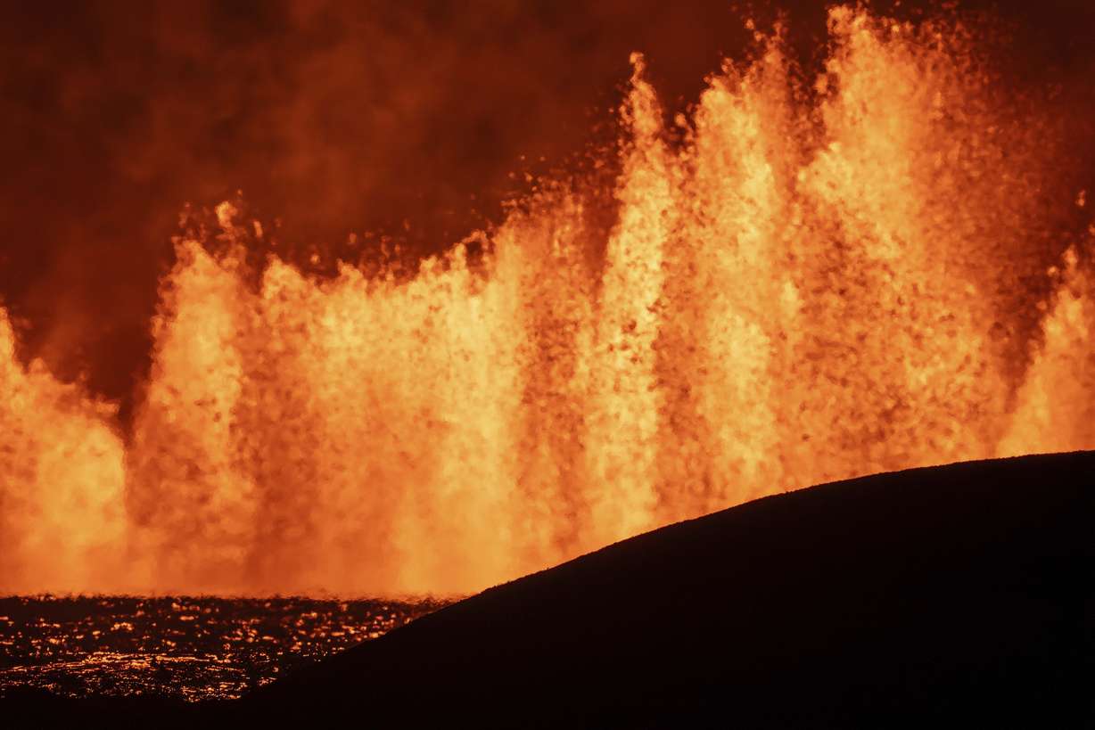 View of the lava fountains pouring out from the new eruptive fissure opened at Svartsengi volcanic system, Iceland, Thursday, in a similar location as the previous eruptions. The fissure is 2.4 miles north of Grindavik.