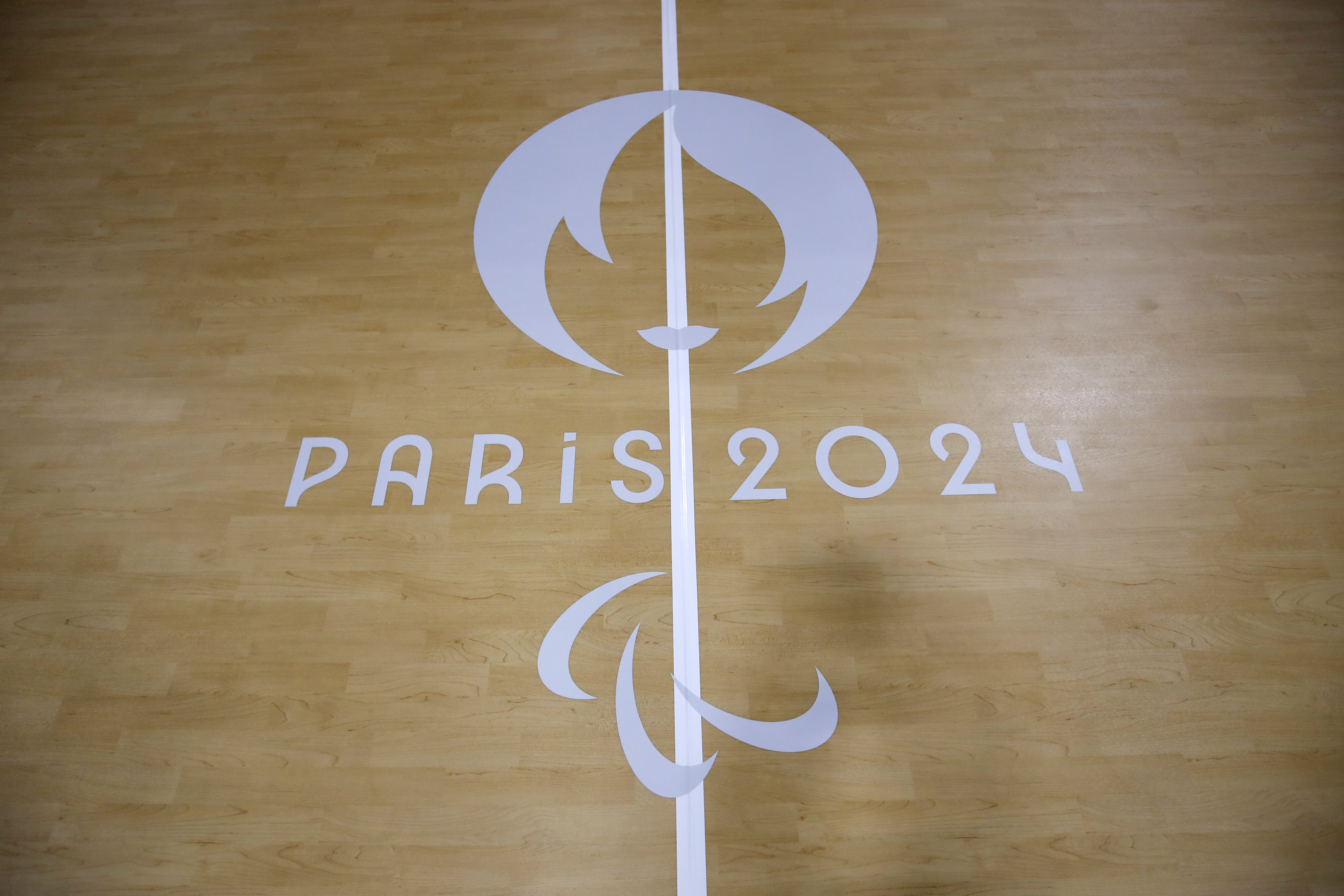 FILE - The logo of the Paralympic Games is seen on the Goalball pitch during a visit of the Arena Paris Sud venue ahead of the Paralympic Games, on Aug. 19, 2024 in Paris. The flame will be lit on Saturday Aug. 24, 2024 in Stoke Mandeville, a village northwest of London and will then travel to France under the English Channel to begin the four-day relay from northern beaches to Paris. 