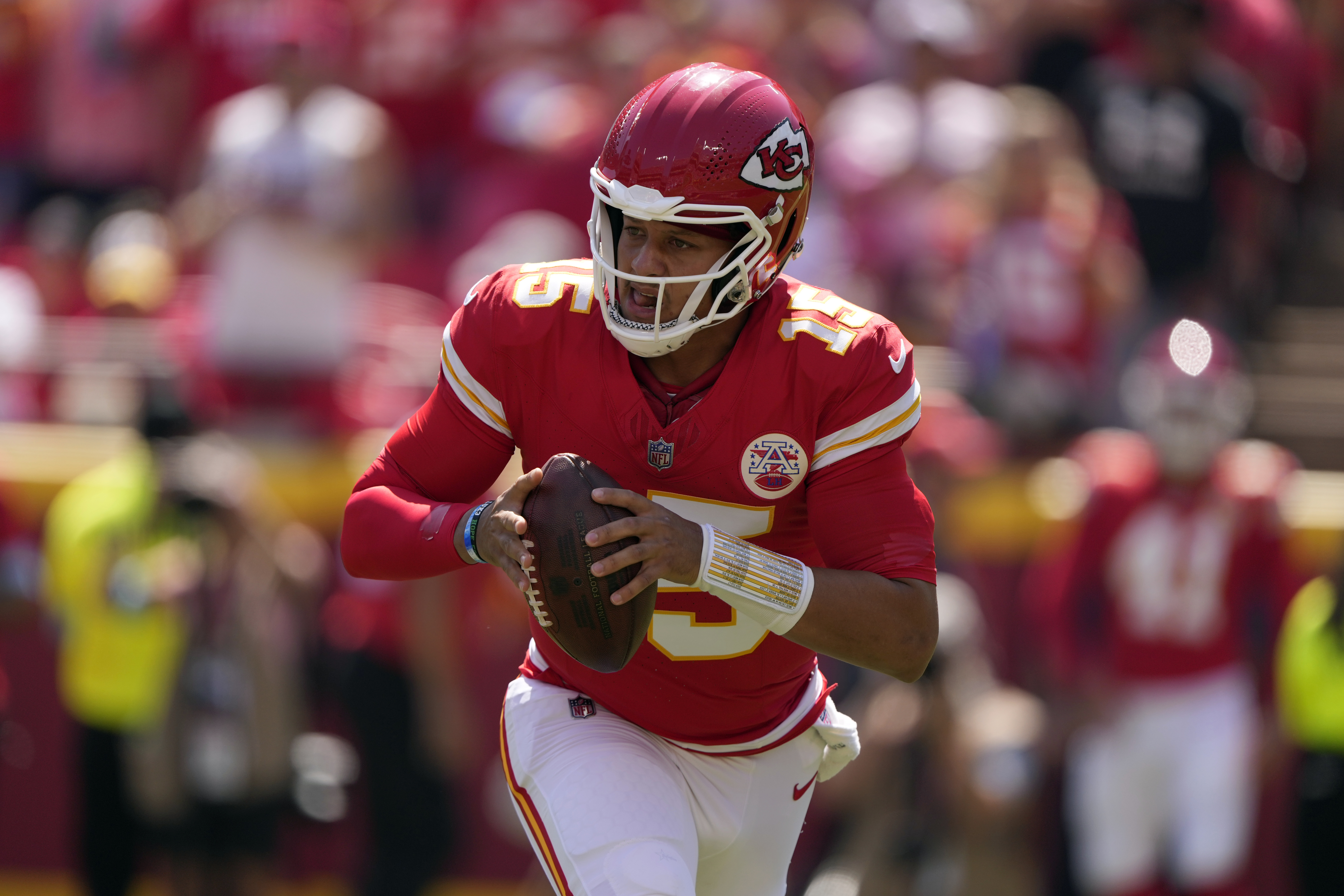 Kansas City Chiefs quarterback Patrick Mahomes (15) rolls out to pass against the Detroit Lions during the first half of an NFL preseason football game Saturday, Aug. 17, 2024, in Kansas City, Mo. 