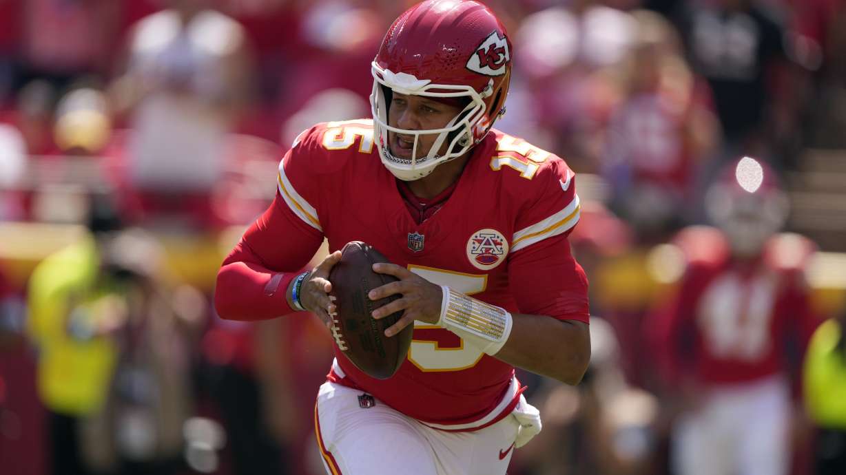 Kansas City Chiefs quarterback Patrick Mahomes (15) rolls out to pass against the Detroit Lions during the first half of an NFL preseason football game Saturday, Aug. 17, 2024, in Kansas City, Mo.