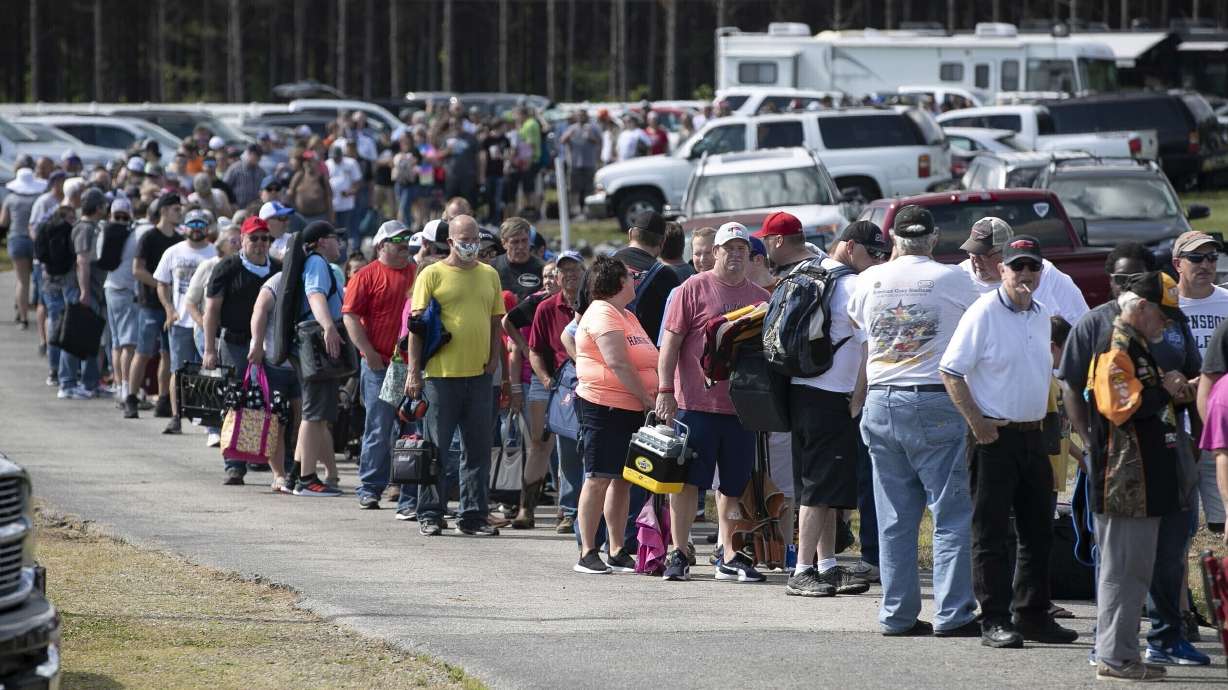 FILE - Hundreds of race fans wait in line to purchase tickets at the Ace Speedway in the rural Alamance County community of Altamahaw near Elon, N.C., on May 23, 2020.