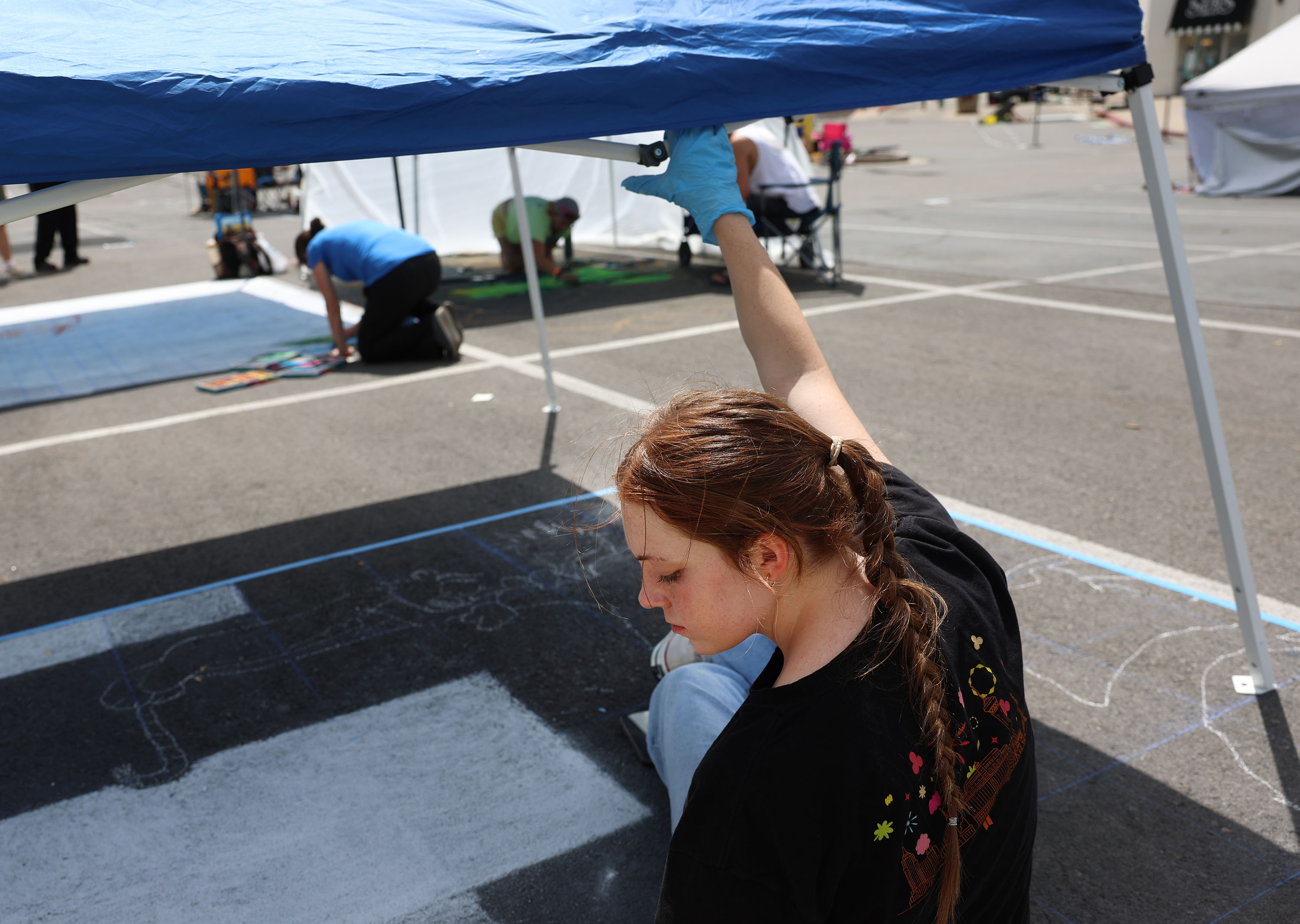 Katie Crabtree of American Fork holds onto her canopy during a blast of wind at the Chalk the Block for Charity Utah event in Provo on Thursday. Strong winds are forecast for a large chunk of Utah through Saturday.