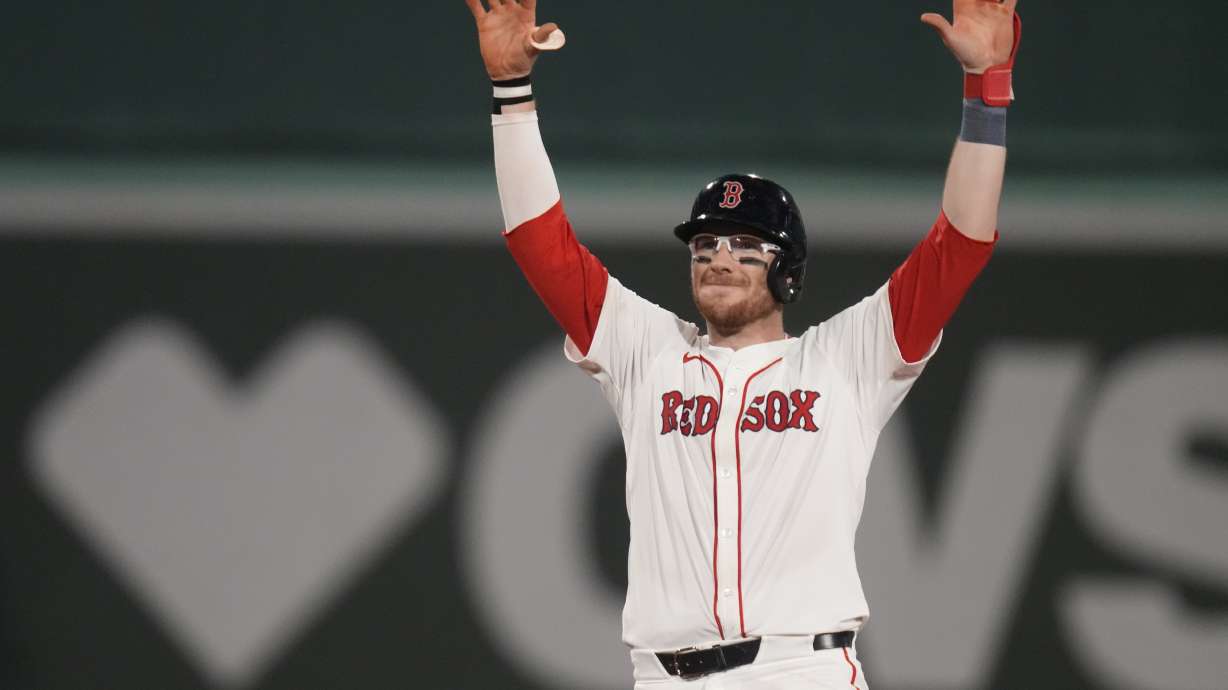 Boston Red Sox's Danny Jansen celebrates after hitting an RBI single during the eighth inning of a baseball game against the Texas Rangers at Fenway Park, Wednesday, Aug. 14, 2024, in Boston.
