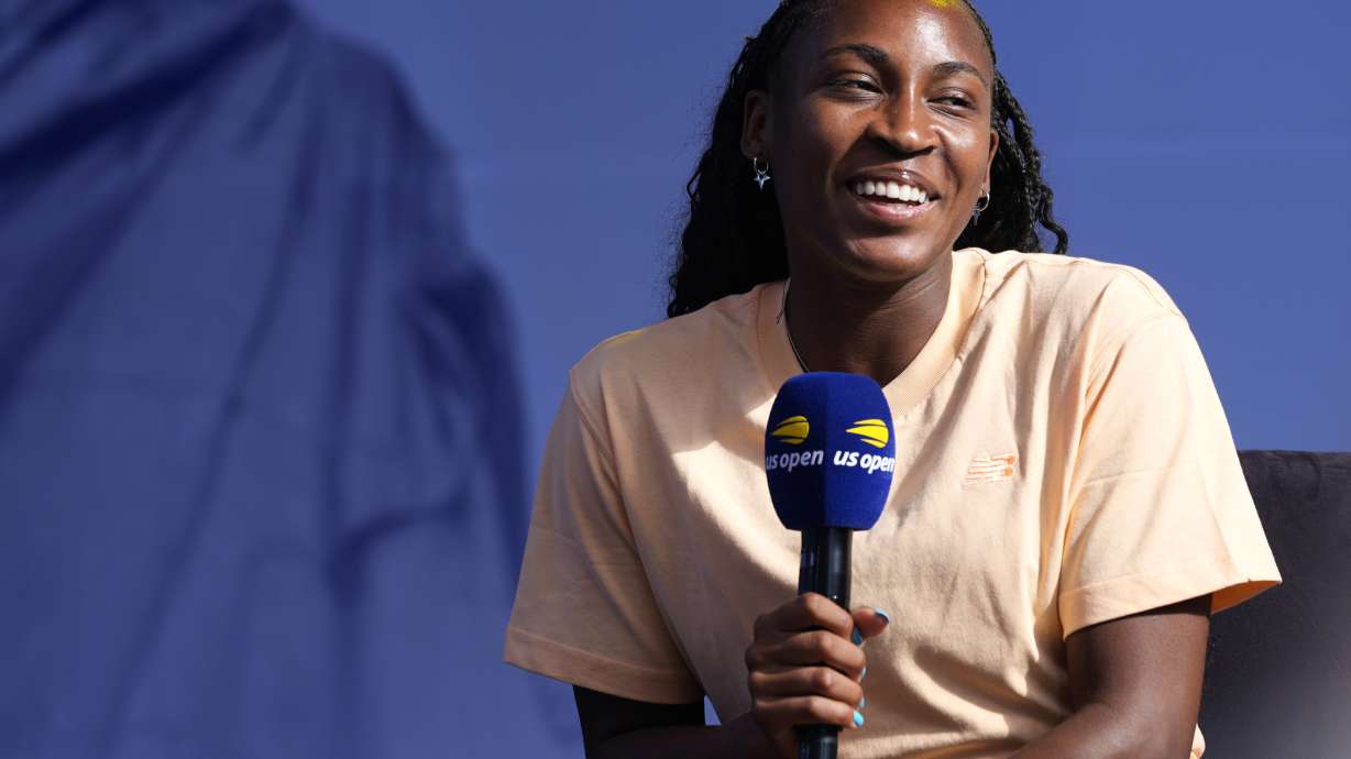 Coco Gauff smiles while speaking to the crowd at the US Open Fan Week at the USTA Billie Jean King National Tennis Center in New York, Tuesday, Aug. 20, 2024.