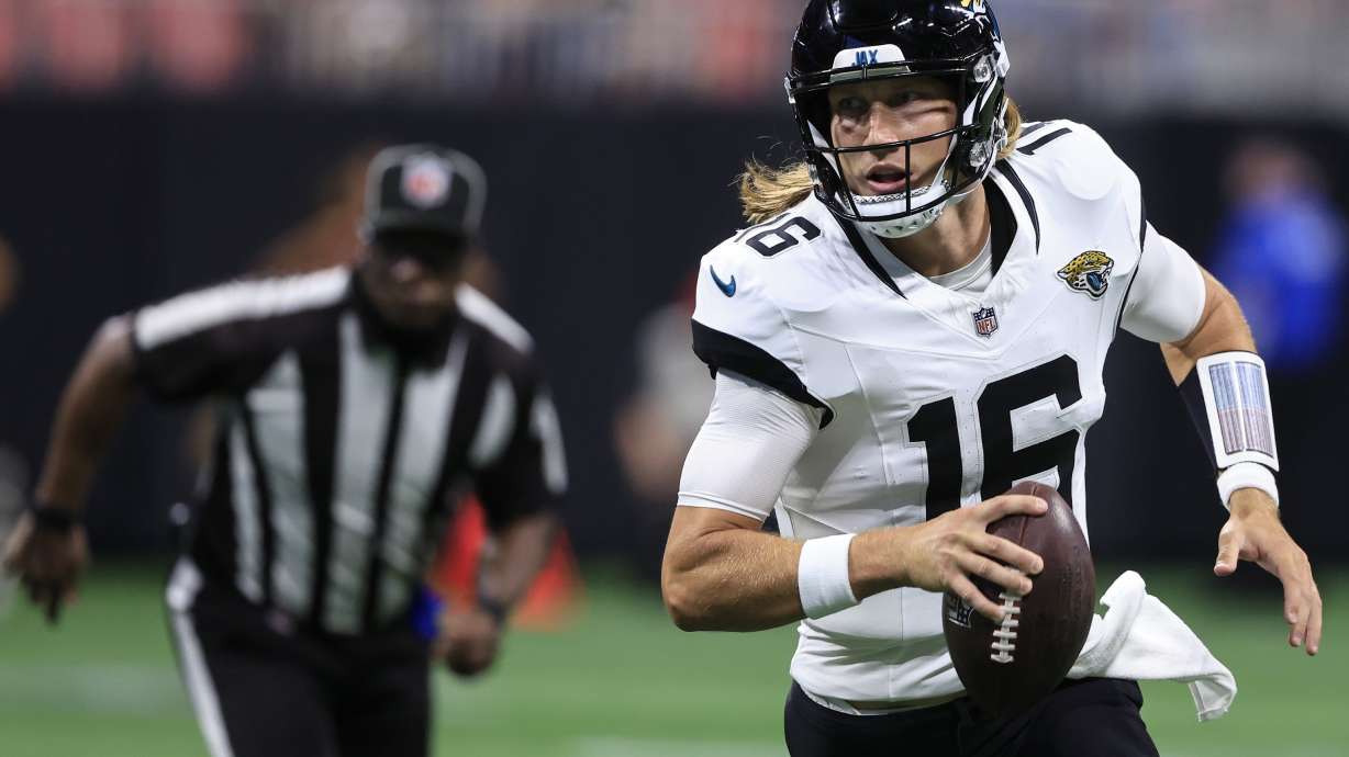 Jacksonville Jaguars quarterback Trevor Lawrence (16) runs out of the pocket against the Atlanta Falcons in the first half of an NFL preseason footballl game, Friday, Aug. 23, 2024, in Atlanta.