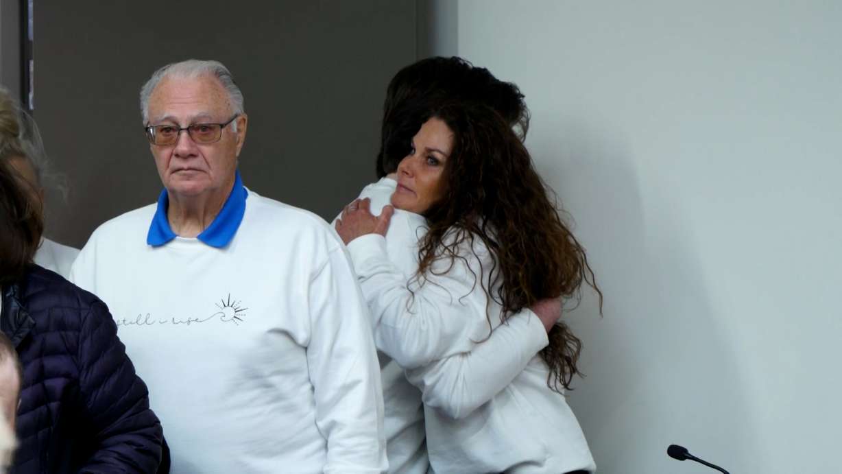 Cami Johnson hugs a family member at a parole board hearing for her ex-husband, Byron Thad Haderlie, on Tuesday.