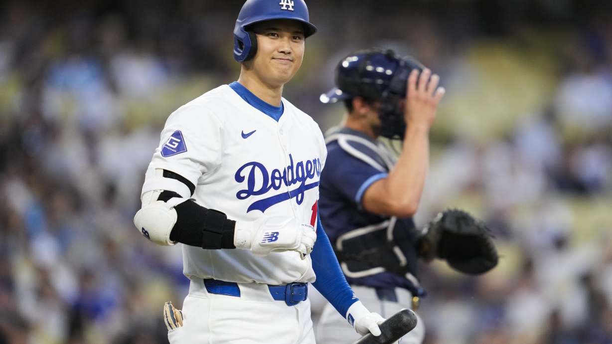 Los Angeles Dodgers designated hitter Shohei Ohtani (17) greets the Tampa Bay Rays dugout during the first inning of a baseball game in Los Angeles, Friday, Aug. 23, 2024.