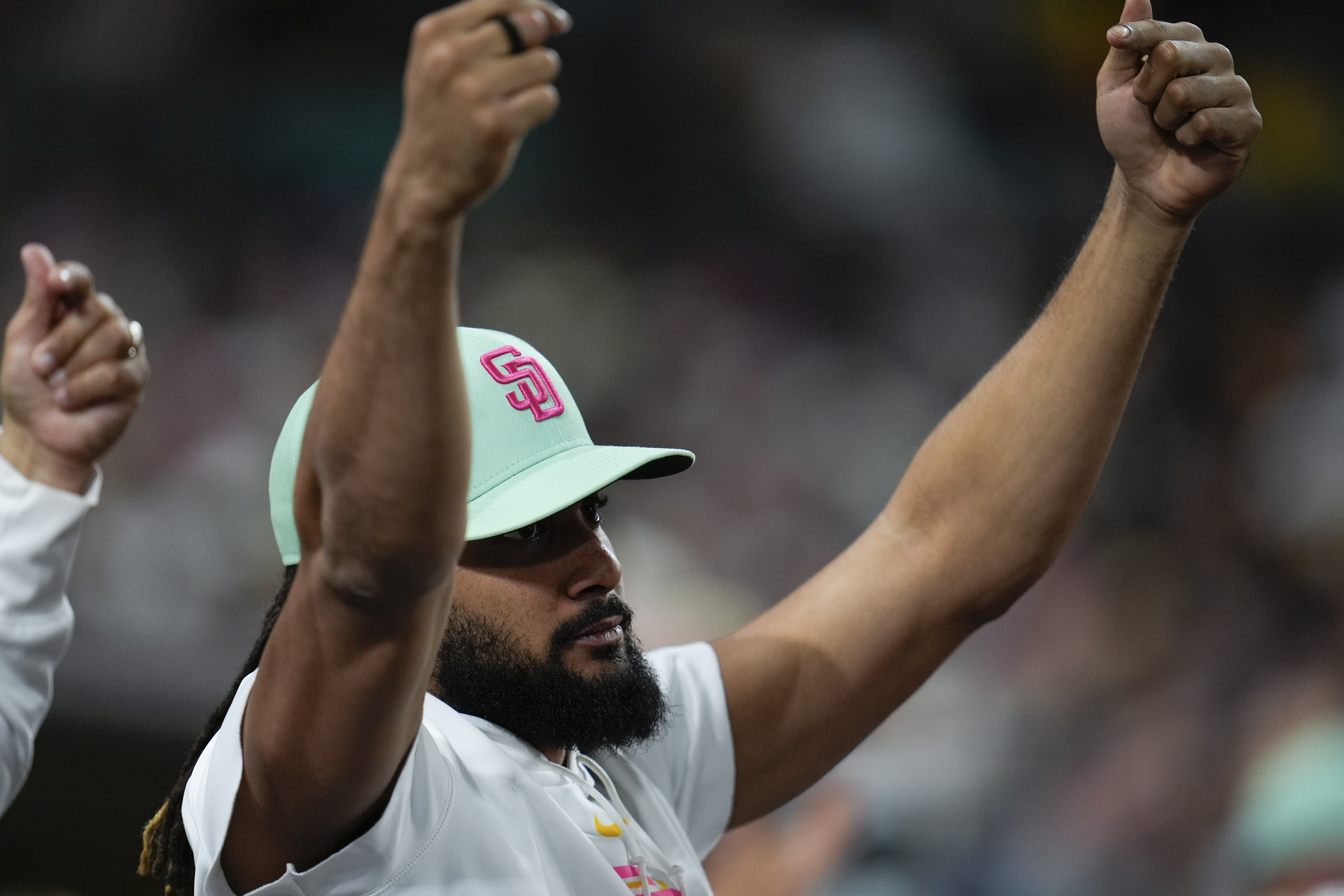 San Diego Padres's Fernando Tatis Jr. celebrates in the dugout after a single by teammate David Peralta during the seventh inning of a baseball game against the New York Mets, Friday, Aug. 23, 2024, in San Diego.