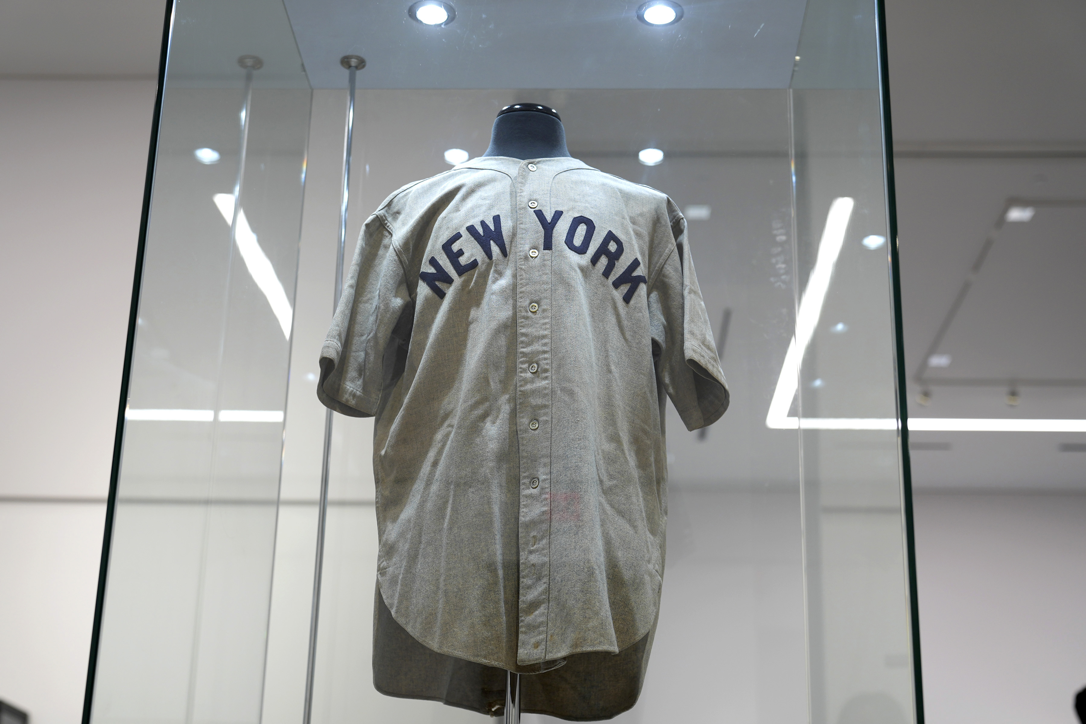 The 1932 Babe Ruth game worn New York Yankees World Series "Called Shot" jersey is displayed in a sealed glass box at Heritage Auction in Irving, Texas, Wednesday, Aug. 21, 2024.