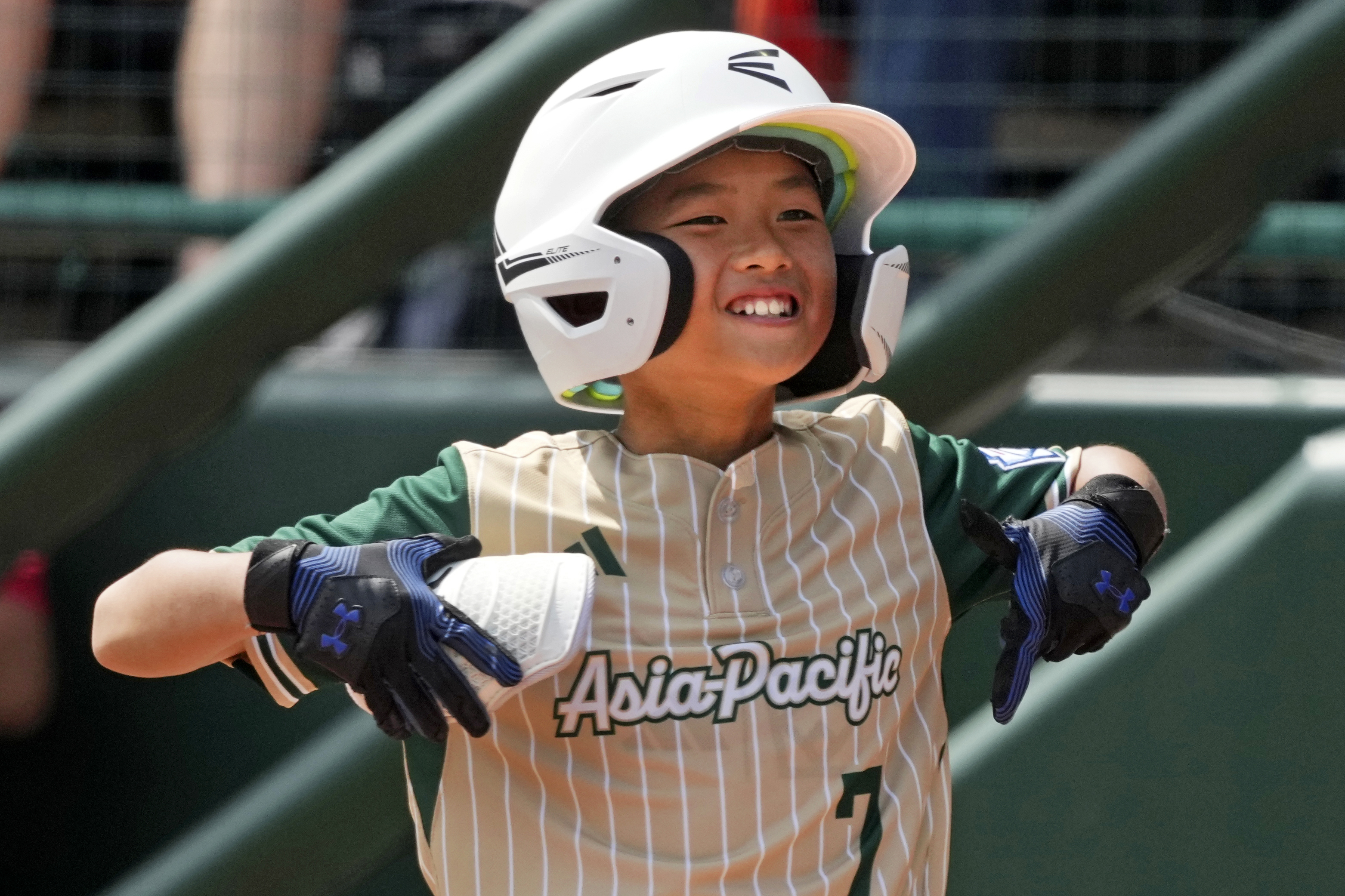 Taiwan's Chen Bo-Wei celebrates as he stands on first base after hitting a single during the fifth inning of the International Championship baseball game against Venezuela at the Little League World Series tournament in South Williamsport, Pa., Saturday, Aug. 24, 2024.