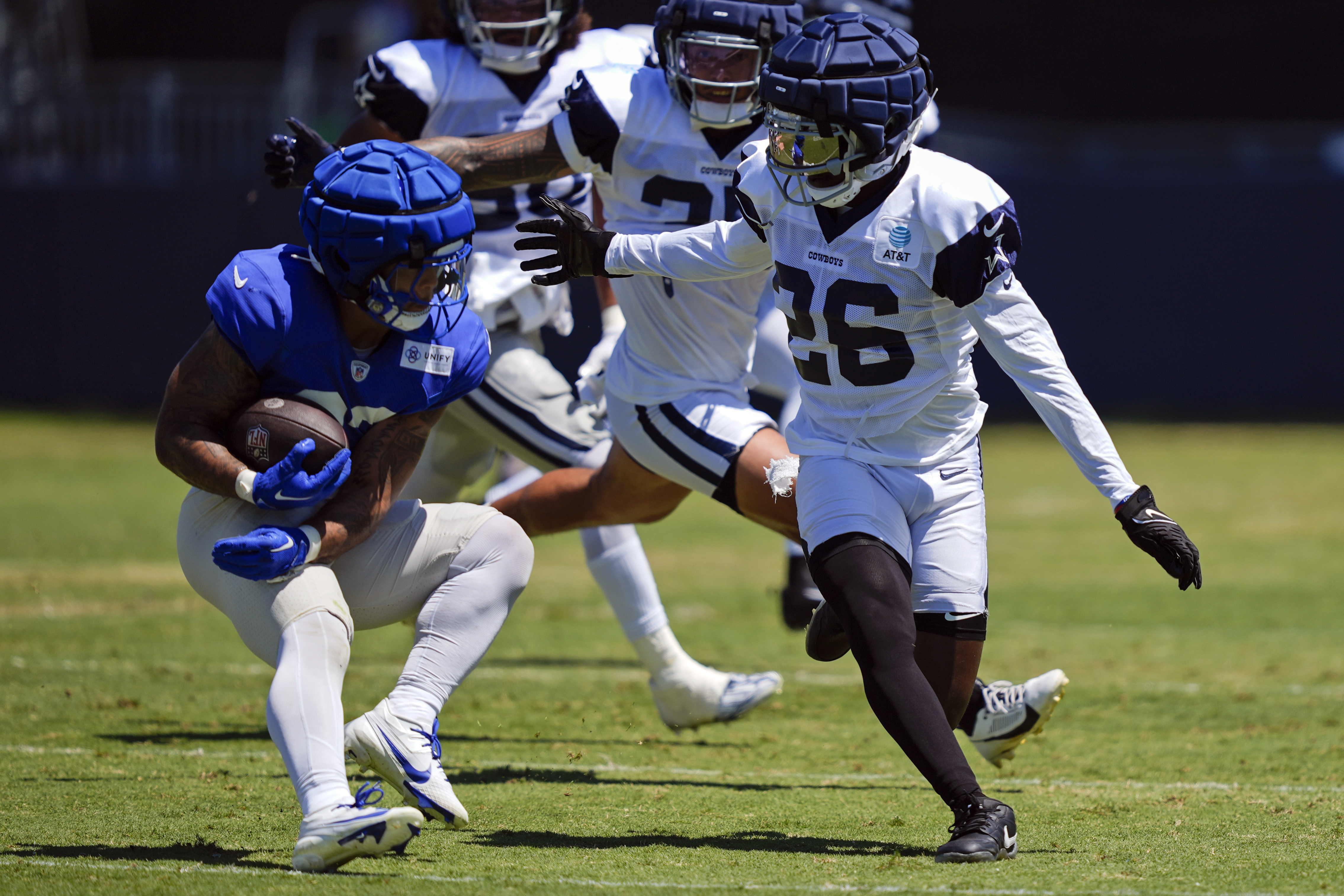 Los Angeles Rams running back Ronnie Rivers, left, and Dallas Cowboys cornerback DaRon Bland runs drills during a joint NFL football practice Wednesday, Aug. 14, 2024, in Oxnard, Calif. 