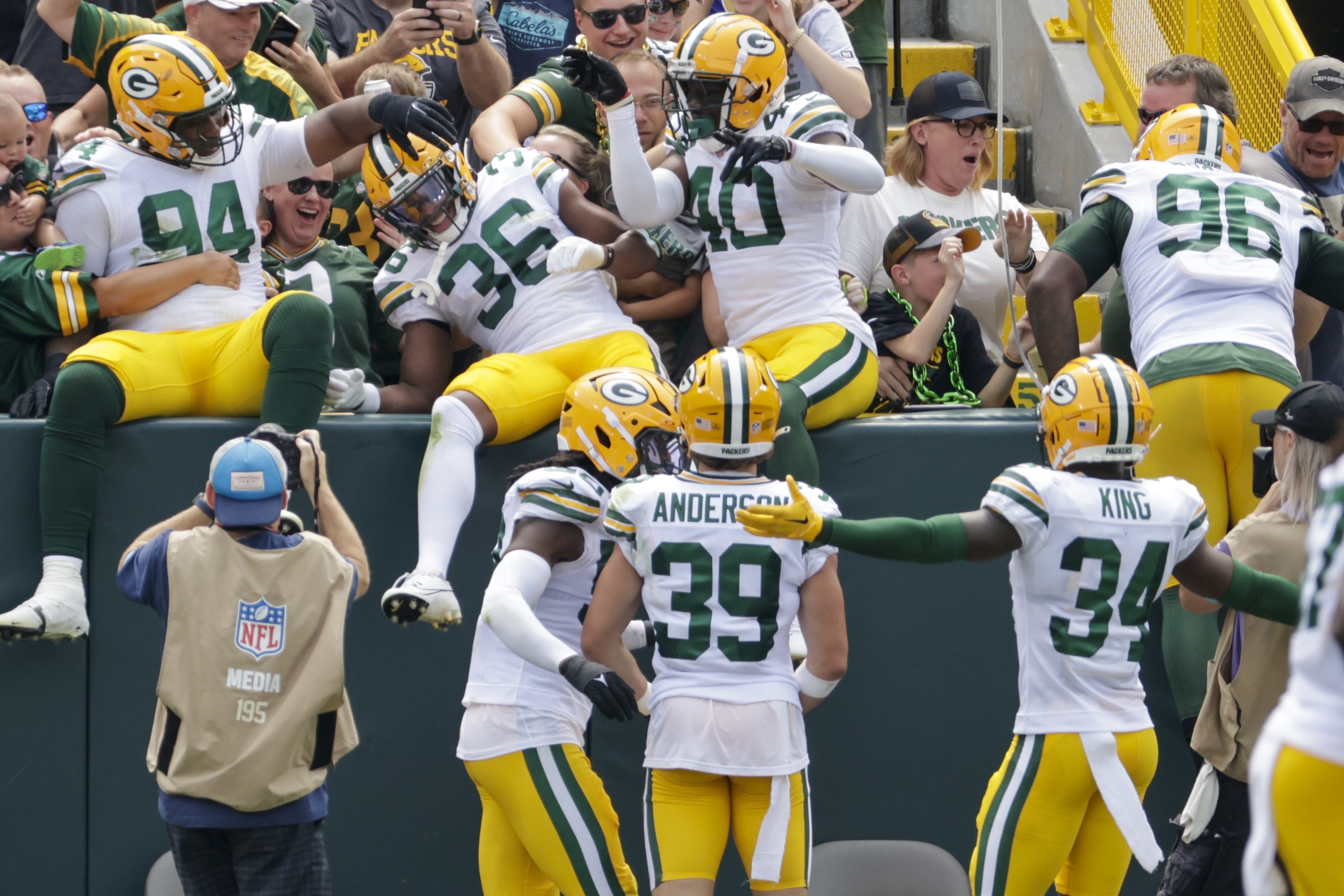 The Green Bay Packers defense celebrates after a strip and runback for a touchdown during the first half of a preseason NFL football game against the Baltimore Ravens Saturday, Aug. 24, 2024, in Green Bay, Wis.