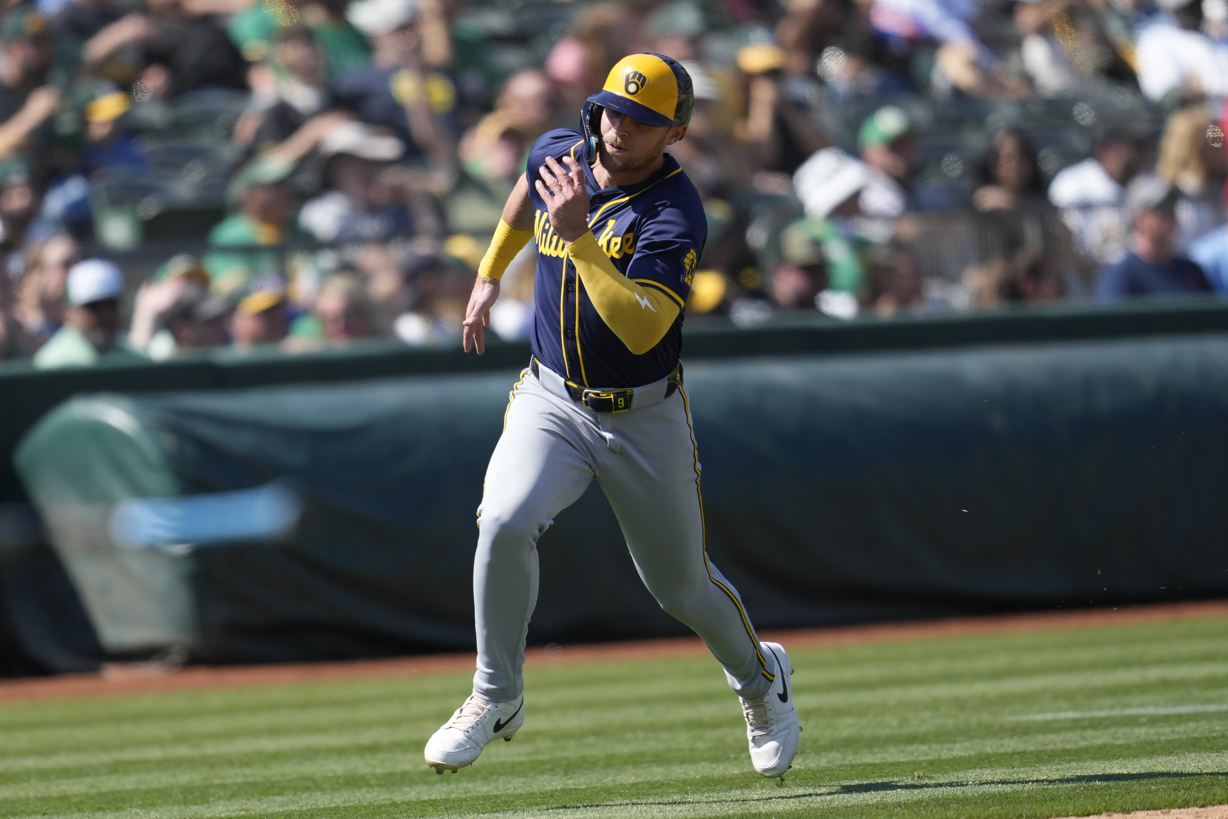 Milwaukee Brewers' Jake Bauers runs home to score against the Oakland Athletics during the eighth inning of a baseball game in Oakland, Calif., Saturday, Aug. 24, 2024. 