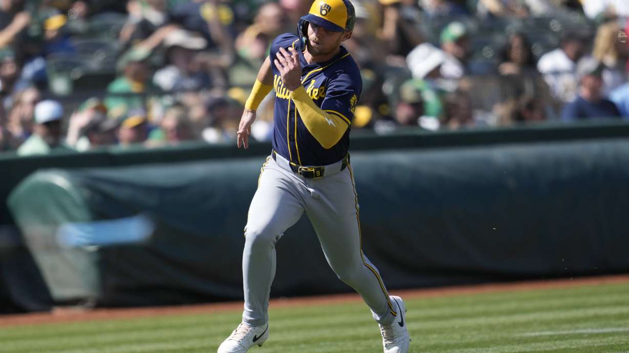 Milwaukee Brewers' Jake Bauers runs home to score against the Oakland Athletics during the eighth inning of a baseball game in Oakland, Calif., Saturday, Aug. 24, 2024.