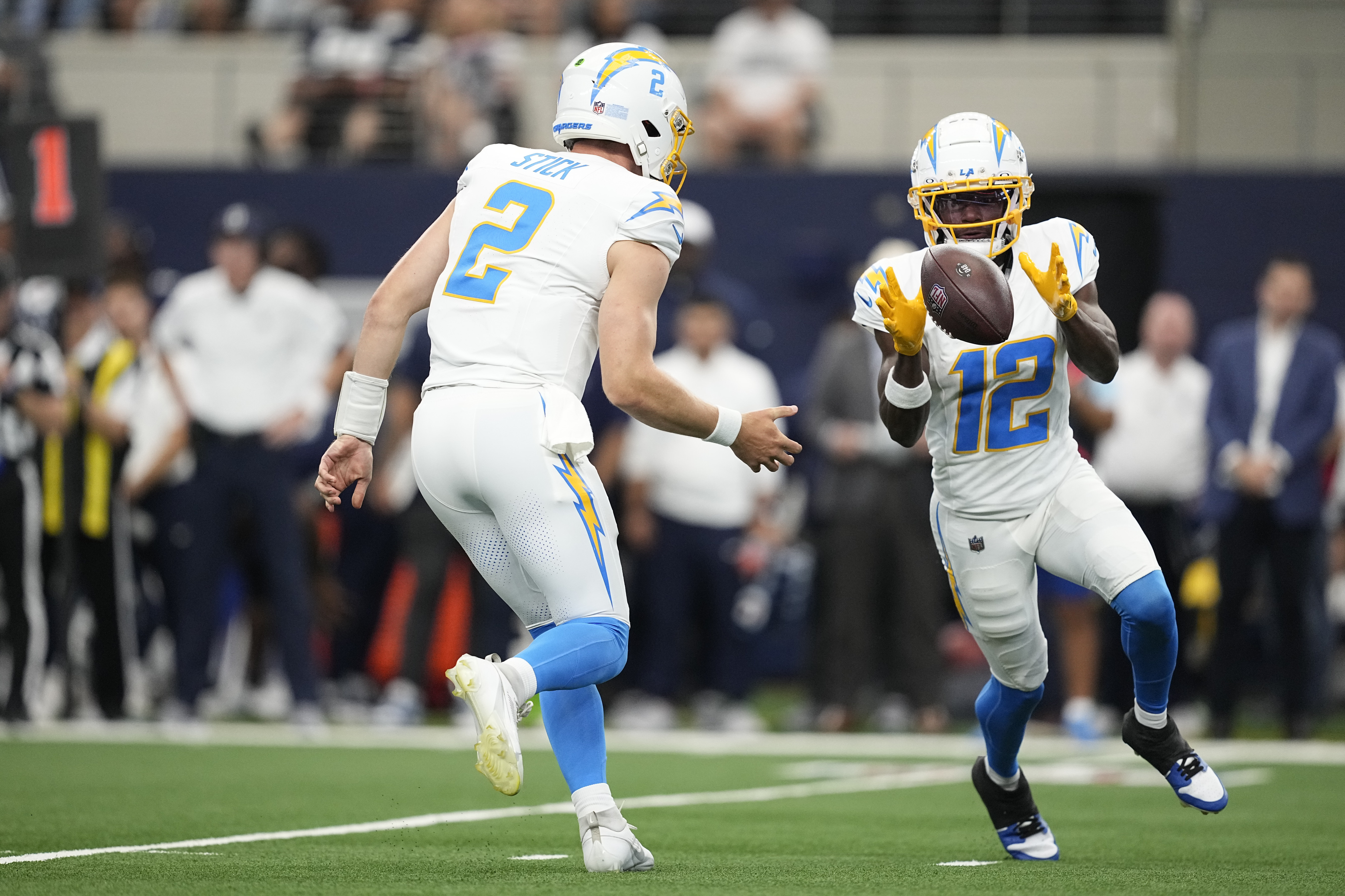 Los Angeles Chargers wide receiver Derius Davis (12) gets the ball pitched to him by quarterback Easton Stick (2), then runs for a touchdown, during the first half of a preseason NFL football game against the Dallas Cowboys, Saturday, Aug. 24, 2024, in Arlington, Texas.