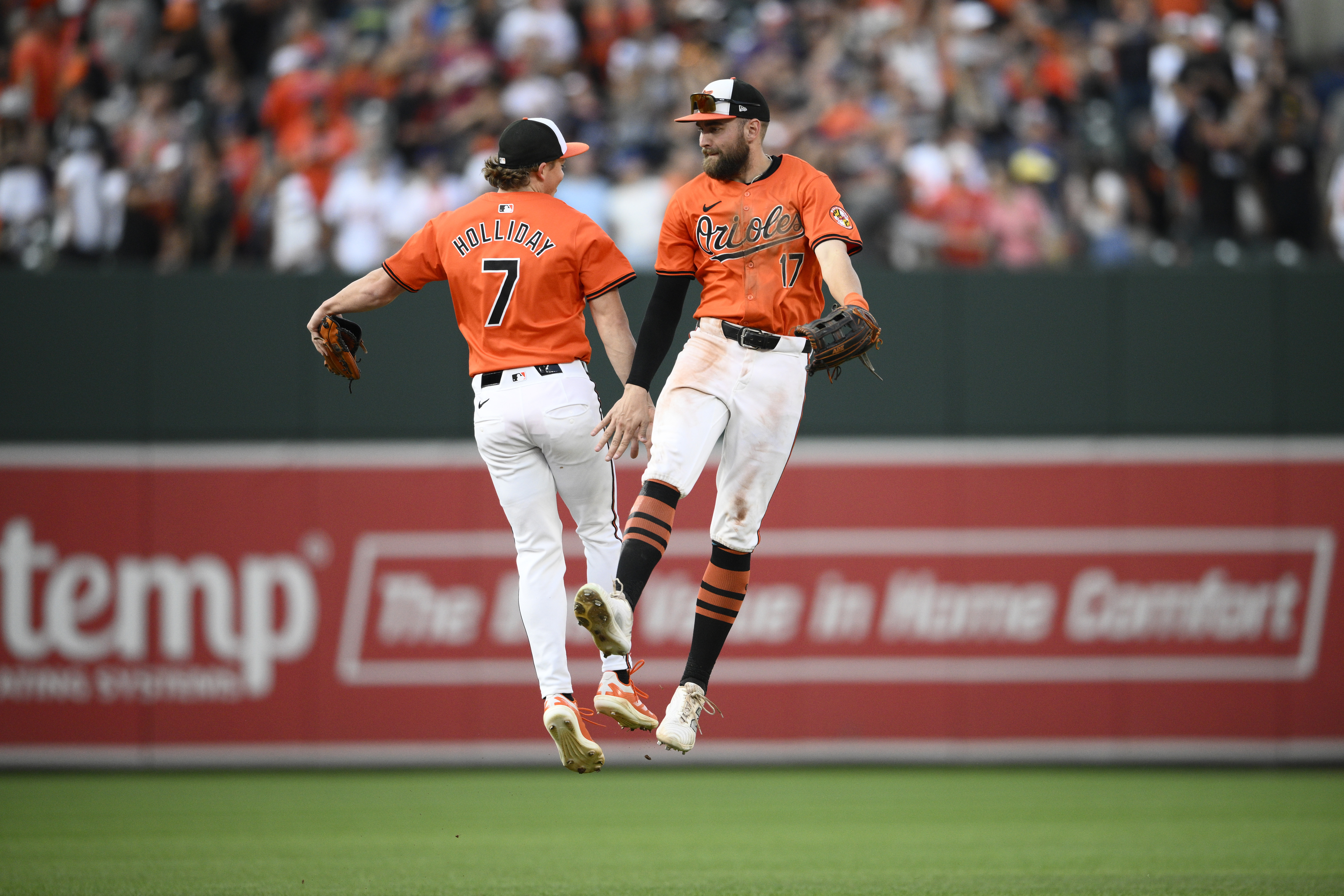 Baltimore Orioles' Jackson Holliday (7) and Colton Cowser (17) celebrate after beating the Houston Astros 3-2 in a baseball game Saturday, Aug. 24, 2024, in Baltimore.
