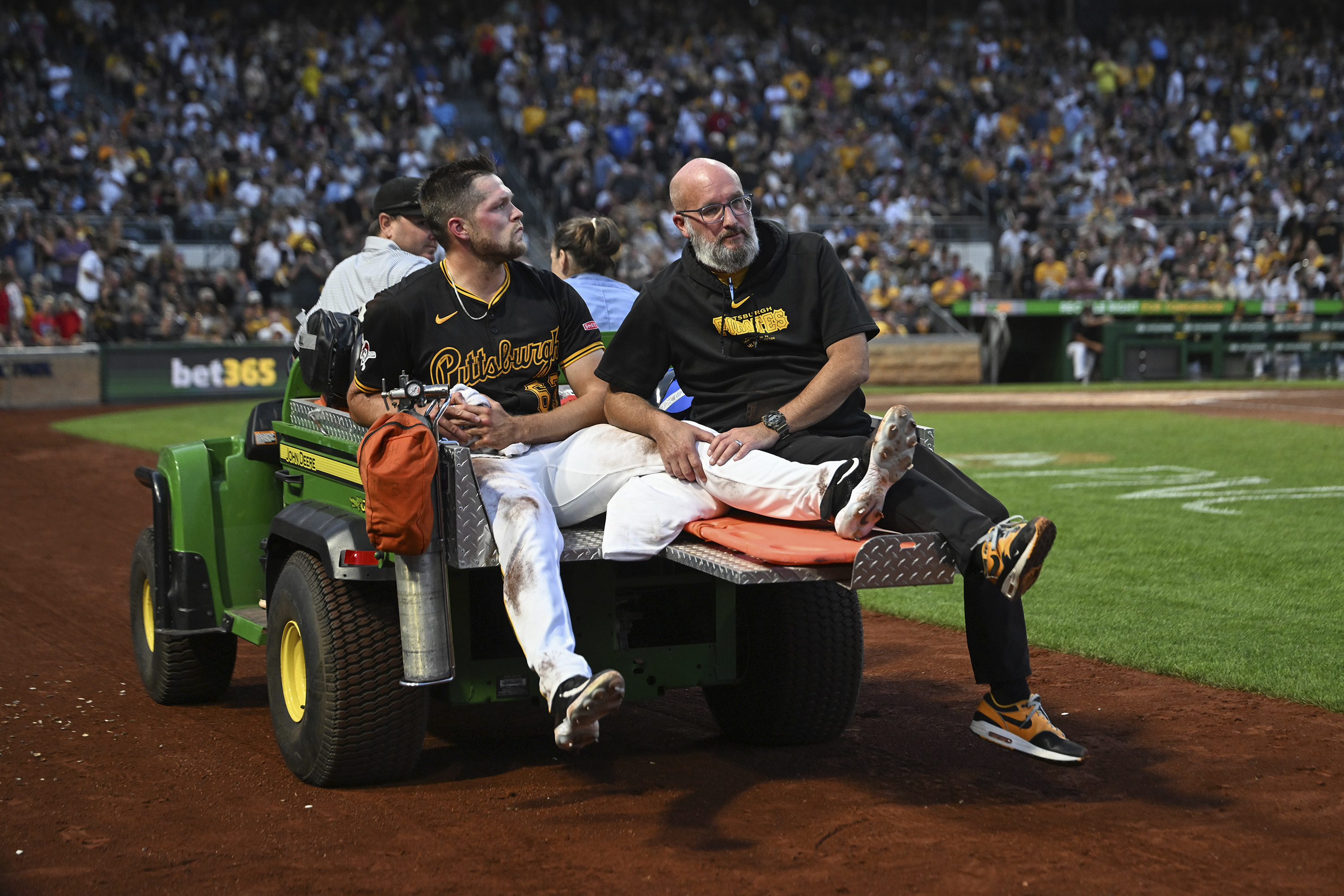 Pittsburgh Pirates pitcher Hunter Stratton, left, is taken from the field after getting injured in the fourth inning of a baseball game against the Cincinnati Reds, Saturday, Aug. 24, 2024, in Pittsburgh. 