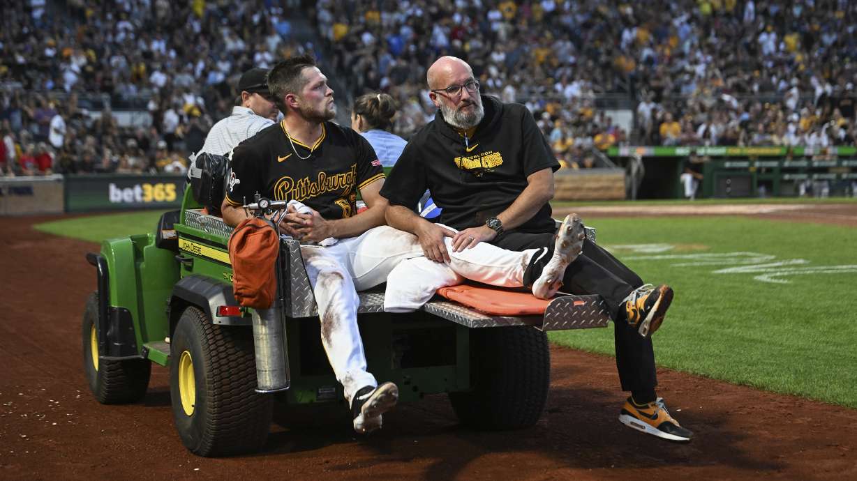 Pittsburgh Pirates pitcher Hunter Stratton, left, is taken from the field after getting injured in the fourth inning of a baseball game against the Cincinnati Reds, Saturday, Aug. 24, 2024, in Pittsburgh.