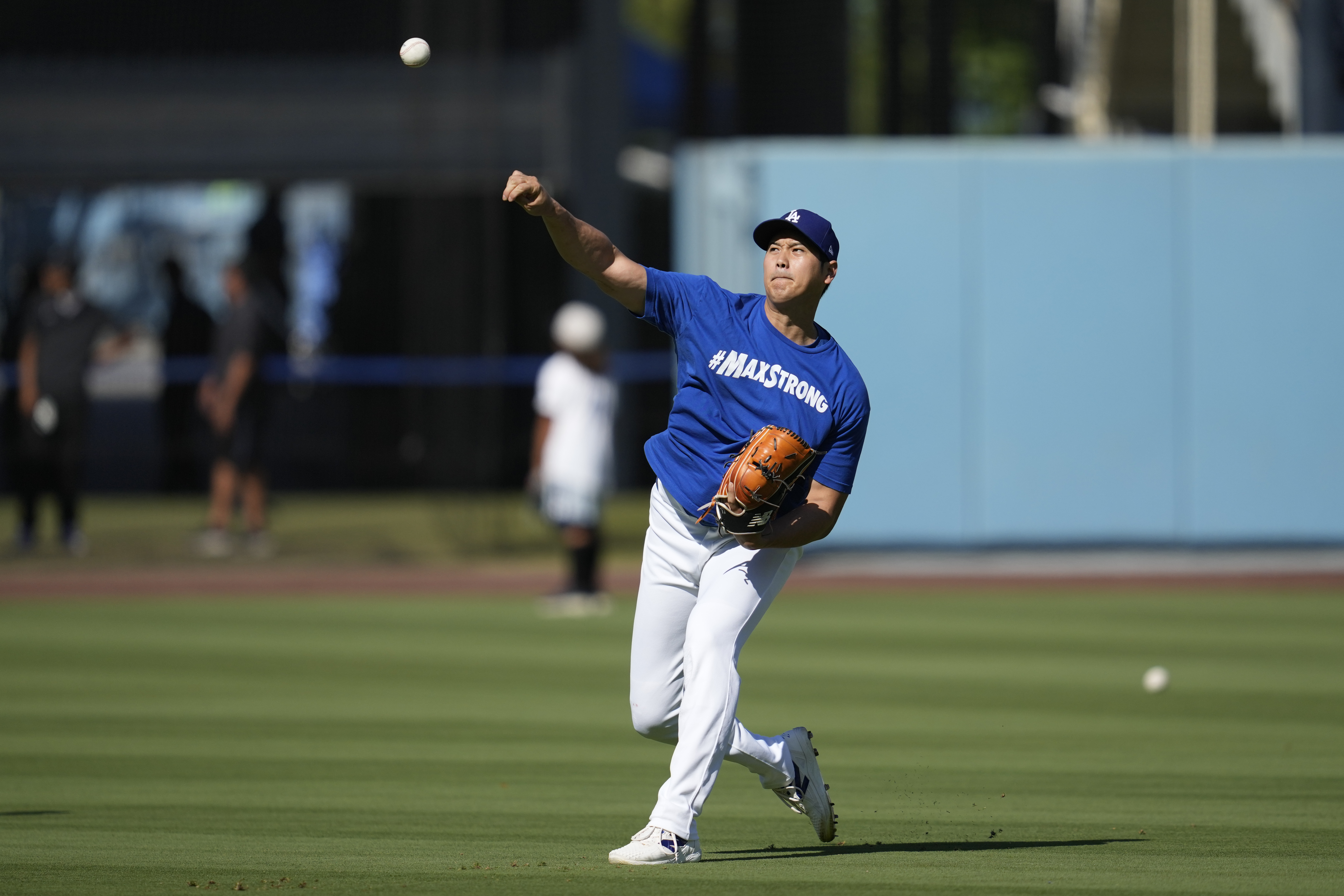 Los Angeles Dodgers designated hitter Shohei Ohtani works out before a baseball game against the Tampa Bay Rays in Los Angeles, Saturday, Aug. 24, 2024. 
