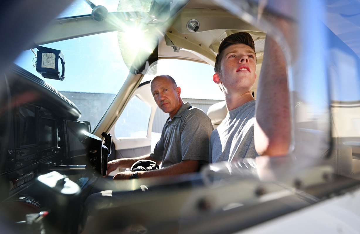 Mason Bingham, a student at Box Elder High, who is training to become a pilot through Utah State University’s Private Pilot Ground School program, and his instructor who is also his father, Jason Bingham, get into the plane for their flight around the Brigham City area on Friday, Aug. 16.