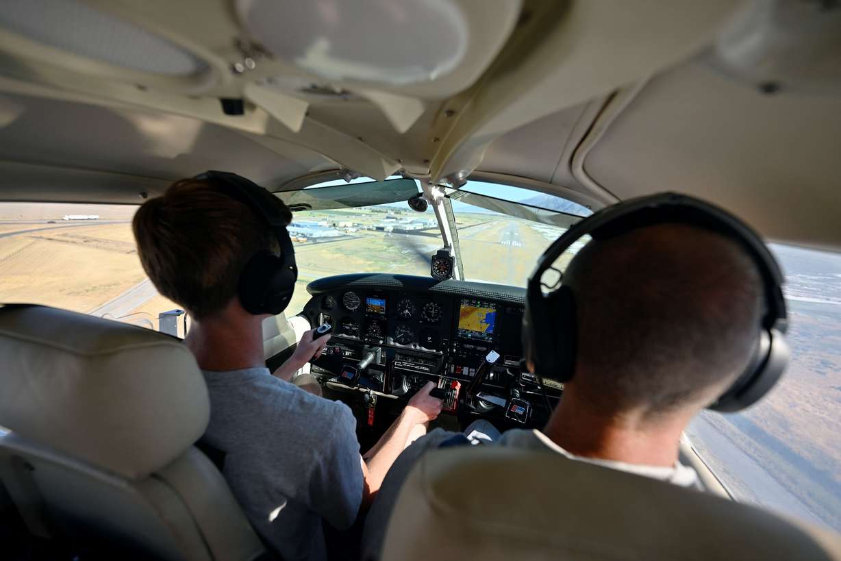 Mason Bingham, a student at Box Elder High, who is training to become a pilot through Utah State University’s Private Pilot Ground School program, watches his approach on a touch and go as he and his instructor, who is also his father, Jason Bingham, fly over the Brigham City area on Friday, Aug. 16.