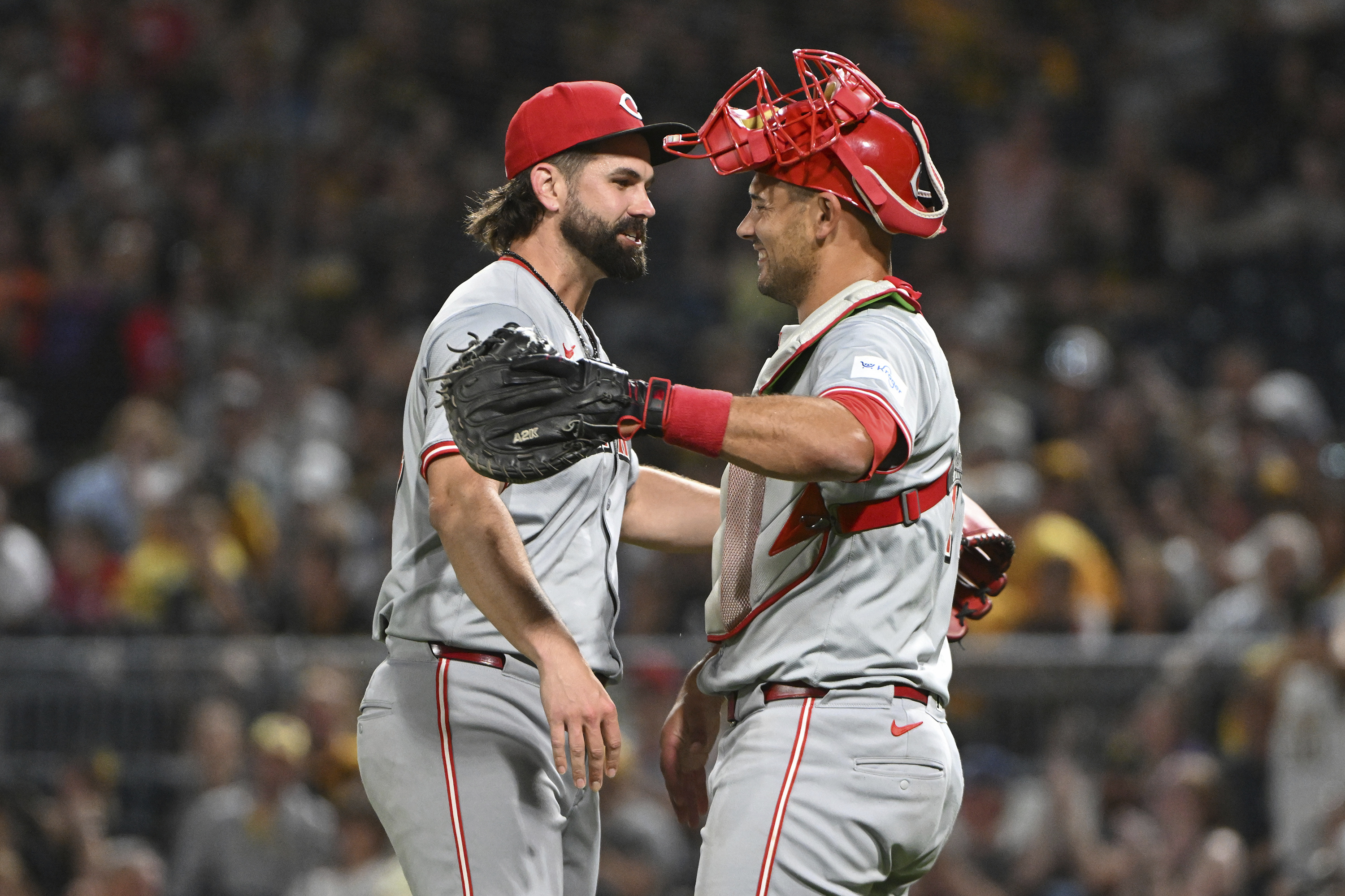 Cincinnati Reds relief pitcher Casey Kelly celebrates with catcher Luke Maile after defeating the Pittsburgh Pirates 10-2 during a baseball game, Saturday, Aug. 24, 2024, in Pittsburgh. 