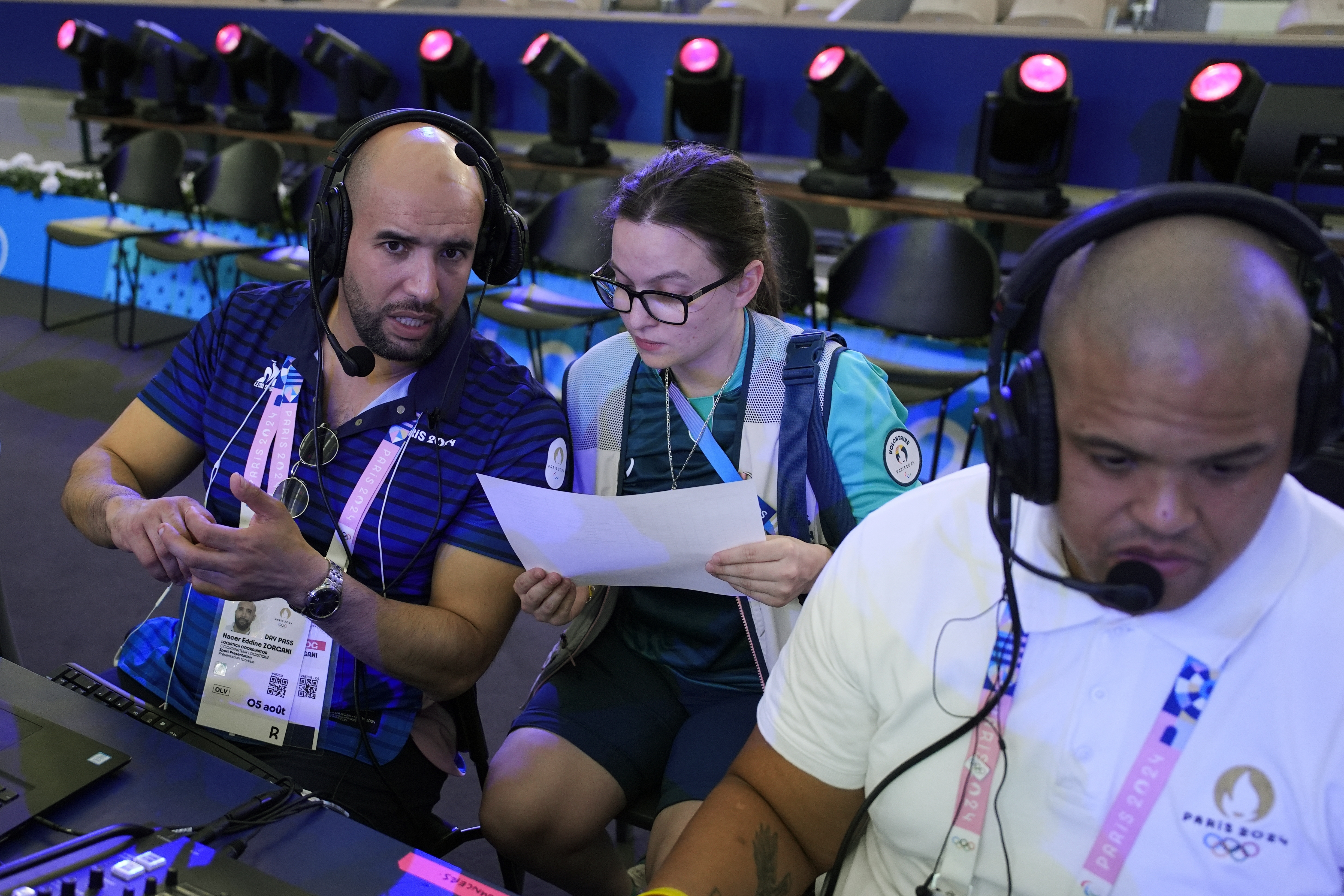Laureline Jeunemaitre, 24, right, assists Nacer Eddine Zorgani as he prepares for the night's boxing matches at the 2024 Summer Olympics, Thursday, Aug. 8, 2024, in Paris, France. 