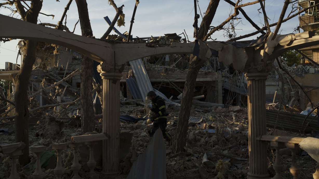 A firefighter collects fragments of a rocket after a Russian strike on Sapphire hotel in Kramatorsk, Donetsk region, Ukraine on Sunday. Reuters news agency said Sunday one of its journalists covering the war in Ukraine was missing and two others were hospitalized after a Russian missile strike on a hotel in the eastern Ukrainian city of Kramatorsk.