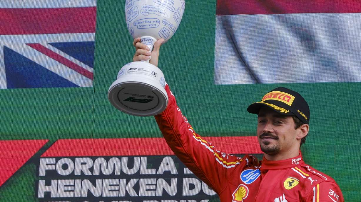 Ferrari driver Charles Leclerc of Monaco celebrates on the podium after placing third at the Formula One Dutch Grand Prix race at the Zandvoort racetrack, Netherlands, Sunday, Aug. 25, 2024.