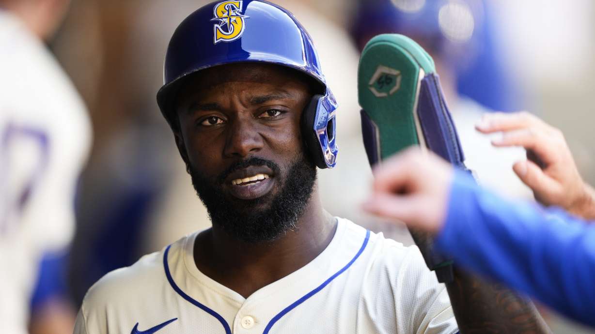 Seattle Mariners' Randy Arozarena is greeted in the dugout after scoring against the San Francisco Giants during the sixth inning of a baseball game, Sunday, Aug. 25, 2024, in Seattle.