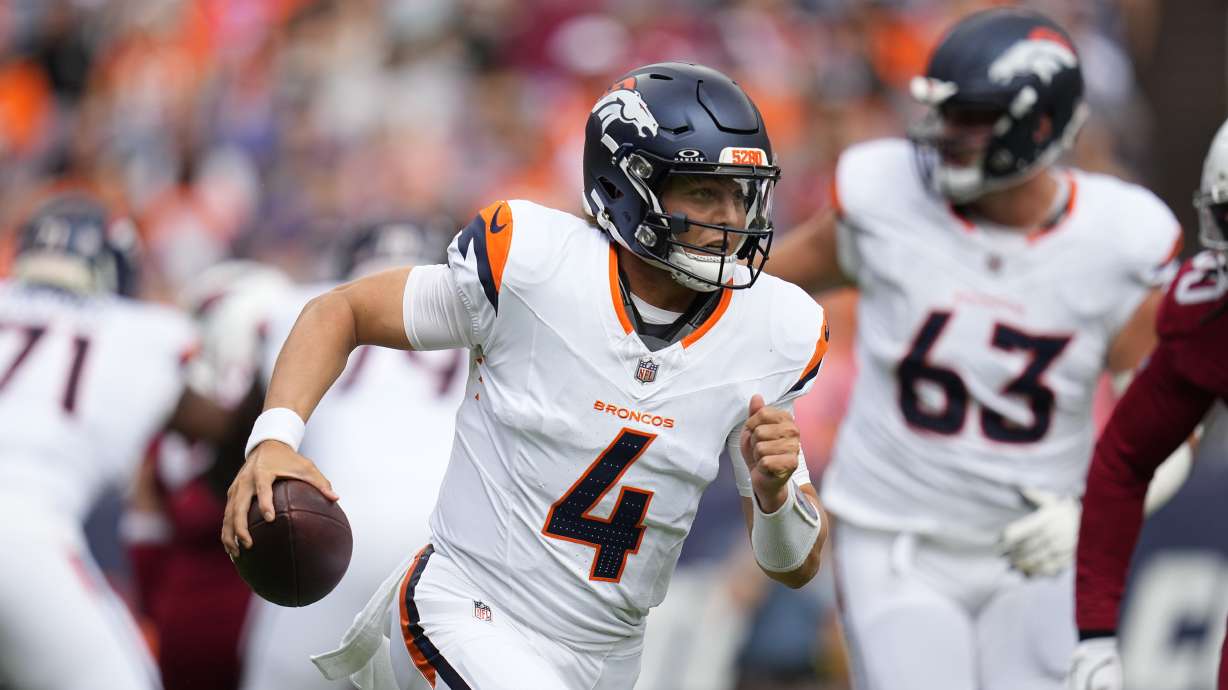 Denver Broncos quarterback Zach Wilson runs with the ball against the Arizona Cardinals during the first half of a preseason NFL football game Sunday in Denver.