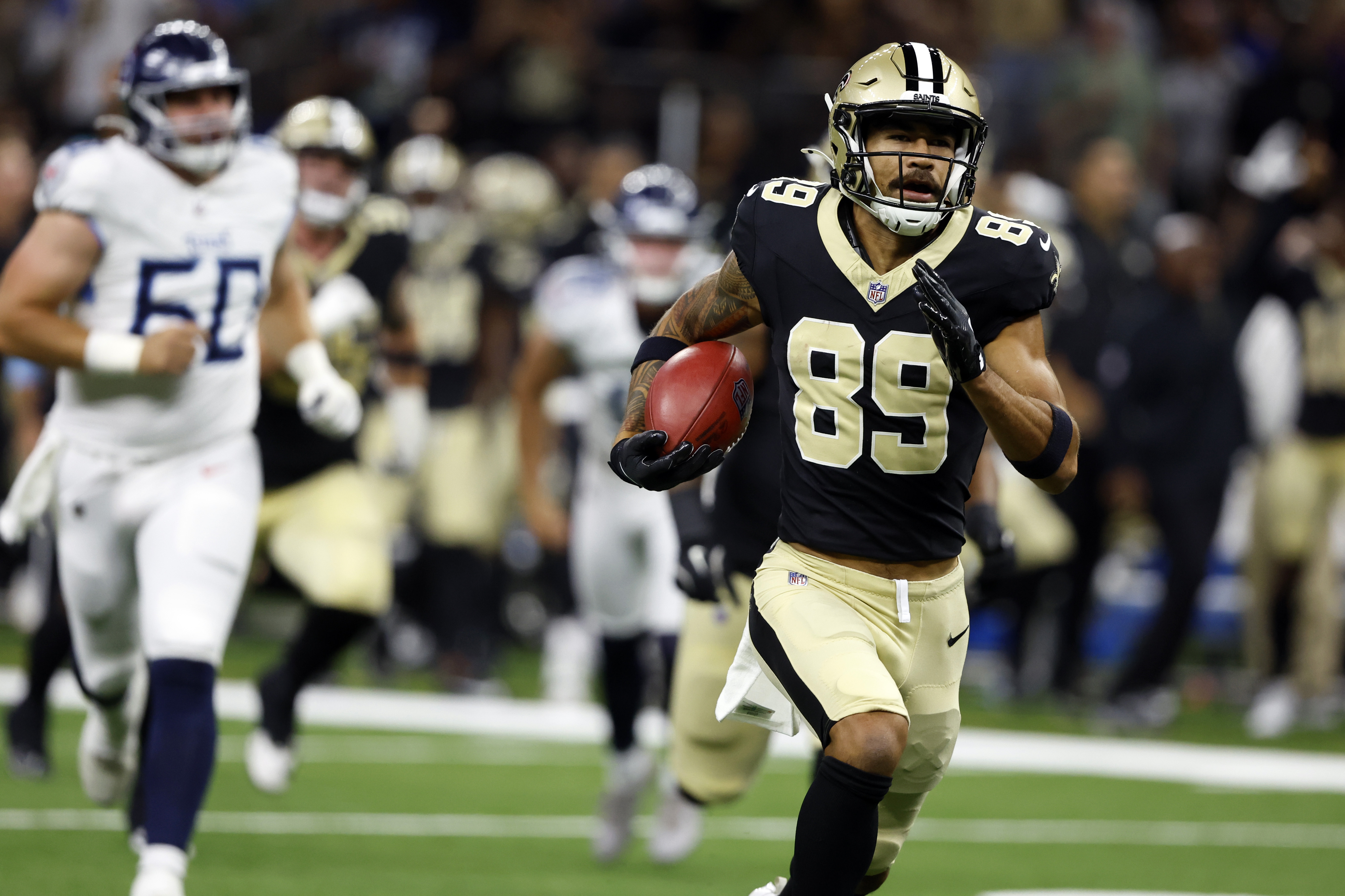 New Orleans Saints' Samson Nacua (89) returns a missed field goal-attempt during the first half of an NFL football game against the Tennessee Titans, Sunday, Aug. 25, 2024, in New Orleans. 
