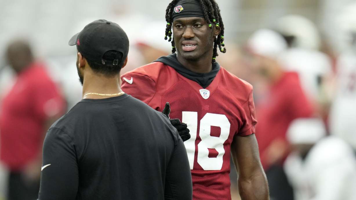 Arizona Cardinals wide receiver Marvin Harrison Jr. (18) talks with Cardinals passing game coordinator/wide receivers coach Drew Terrell as players take part in drills during an NFL football training camp at the State Farm Stadium, Thursday, Aug. 1, 2024, in Glendale, Ariz.
