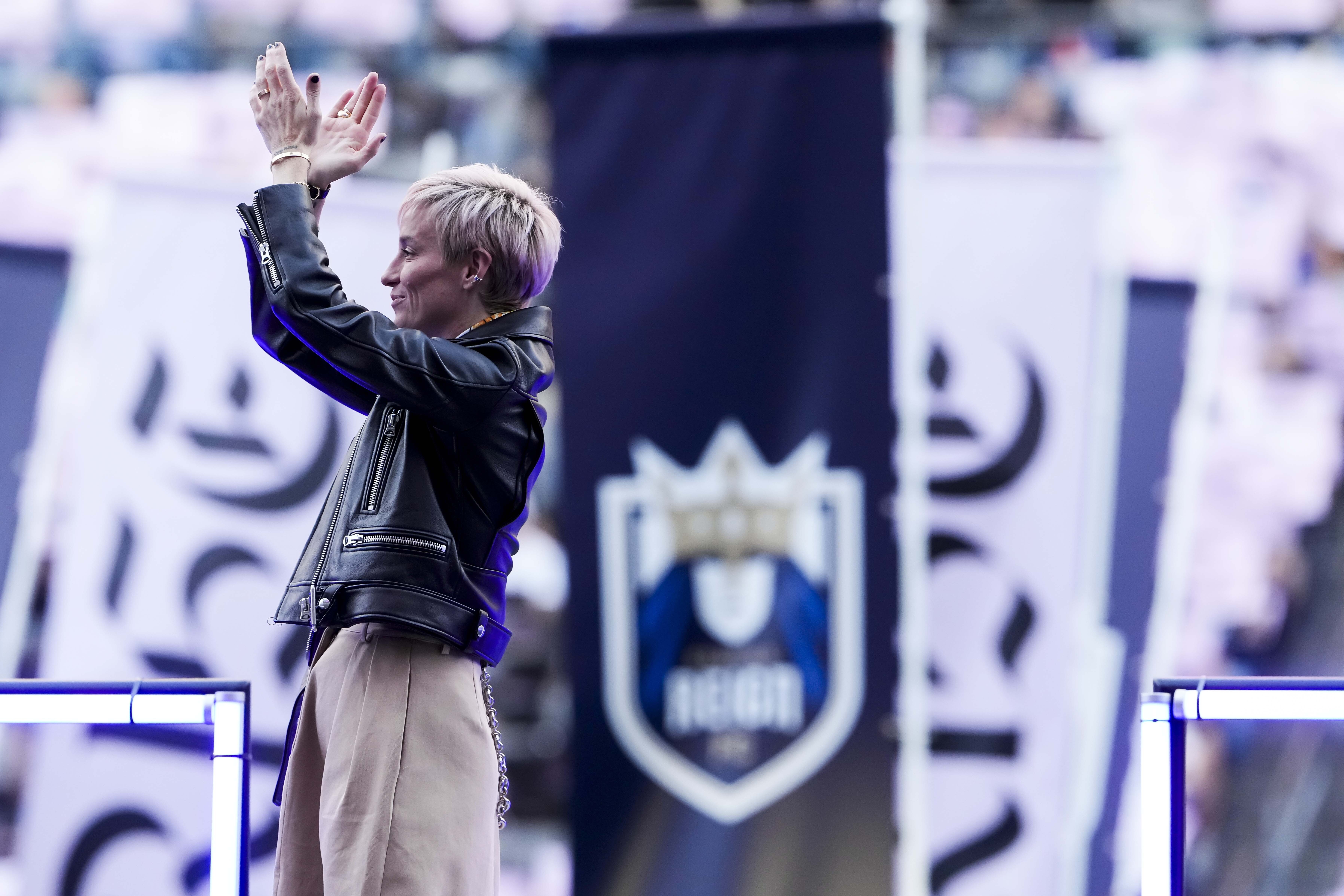 Former Seattle Reign forward Megan Rapinoe acknowledges fans during a ceremony to retire her jersey before an NWSL soccer match against the North Carolina Courage, Sunday, Aug. 25, 2024, in Seattle. 