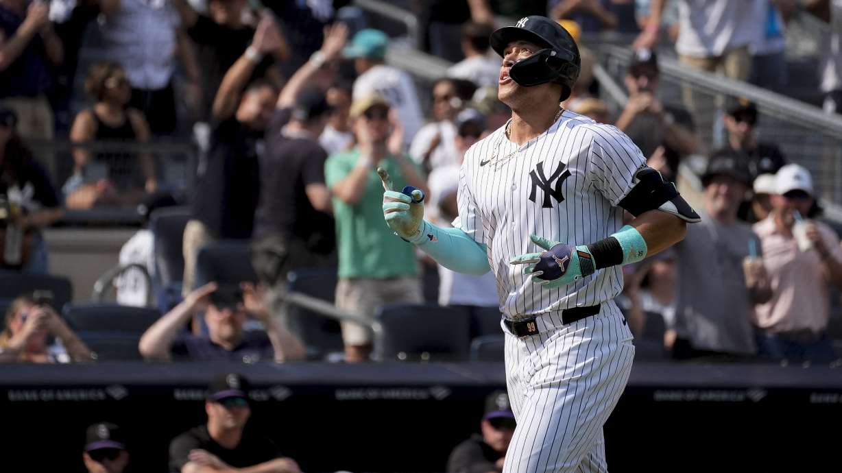 New York Yankees' Aaron Judge crosses home plate after hitting a home run during the seventh inning of a baseball game against the Colorado Rockies, Sunday, Aug. 25, 2024, in New York.