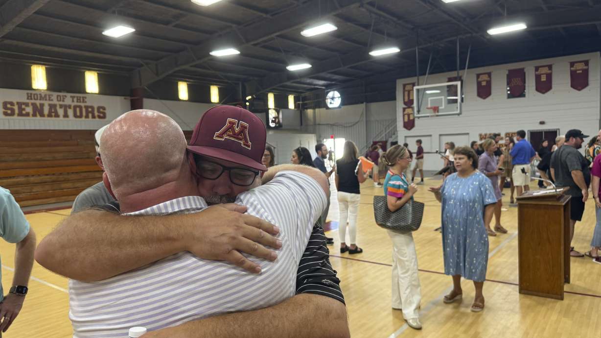 Jamie Tellier, father of Caden Tellier, hugs a student after a memorial service for Tellier's son in Selma, Ala., Monday, Aug. 26, 2024.