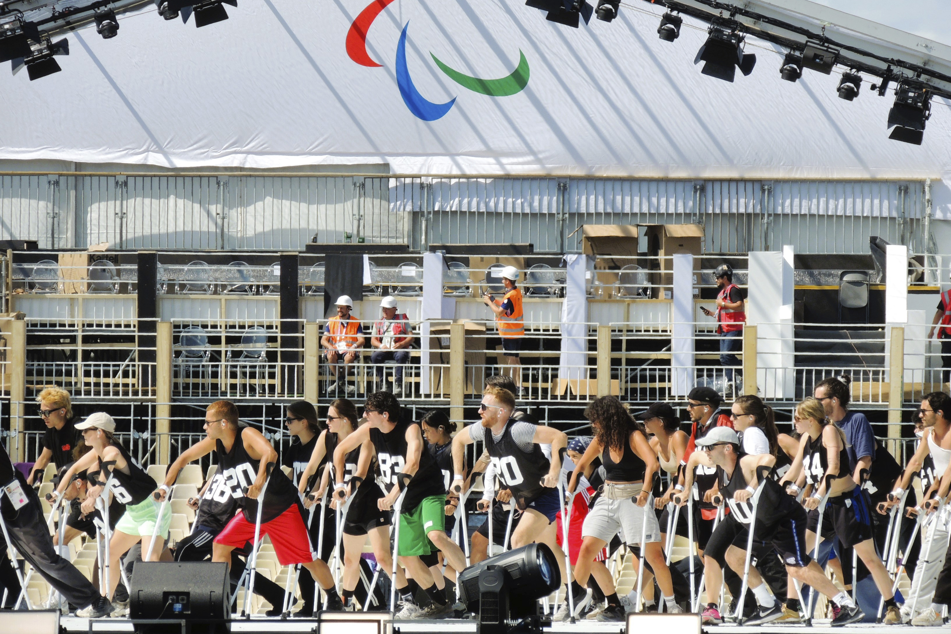 A group of dancers use crutches during the rehearsal of the Paralympic Games opening ceremony in La Concorde square, Monday, Aug. 26, 2024 in Paris, France. 