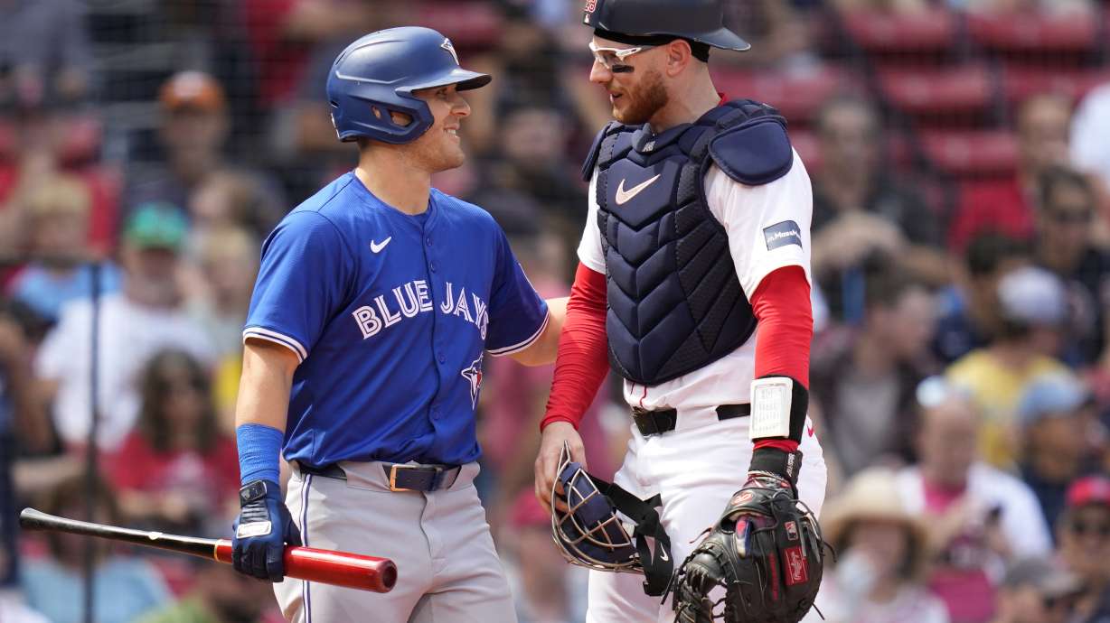 Boston Red Sox catcher Danny Jansen, right, gets a pat on the back from Toronto Blue Jays Daulton Varsho, who pinch-hit for Jansen, during the resumption of the second inning of a baseball game which was delayed due to rain in June, against the Toronto Blue Jays at Fenway Park, Monday, Aug. 26, 2024, in Boston.
