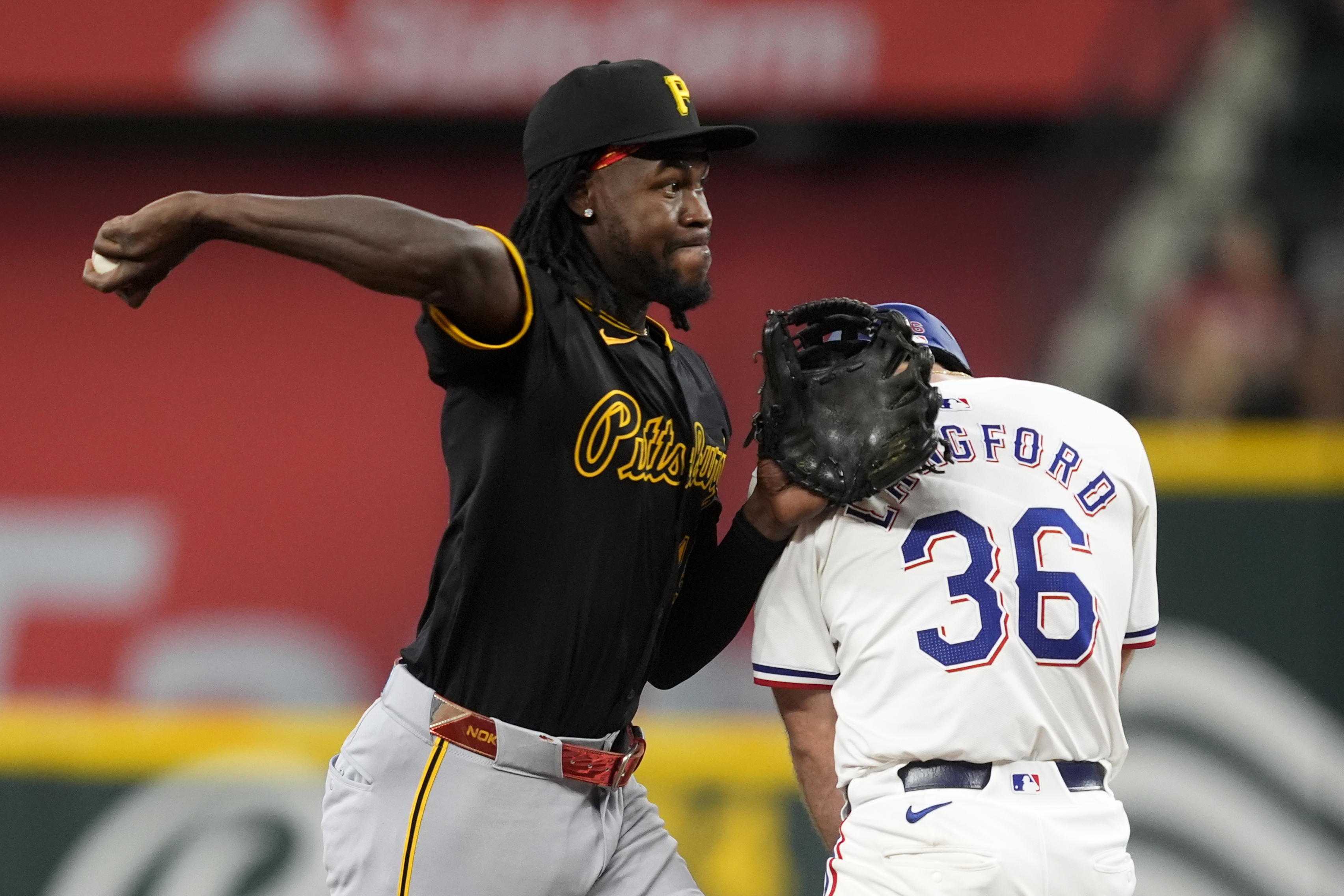 Pittsburgh Pirates shortstop Oneil Cruz throws to first over Texas Rangers' Wyatt Langford (36) to complete a ground out by Travis Jankowski in the second inning of a baseball game, Wednesday, Aug. 21, 2024, in Arlington, Texas. 