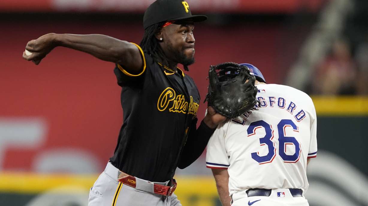 Pittsburgh Pirates shortstop Oneil Cruz throws to first over Texas Rangers' Wyatt Langford (36) to complete a ground out by Travis Jankowski in the second inning of a baseball game, Wednesday, Aug. 21, 2024, in Arlington, Texas.