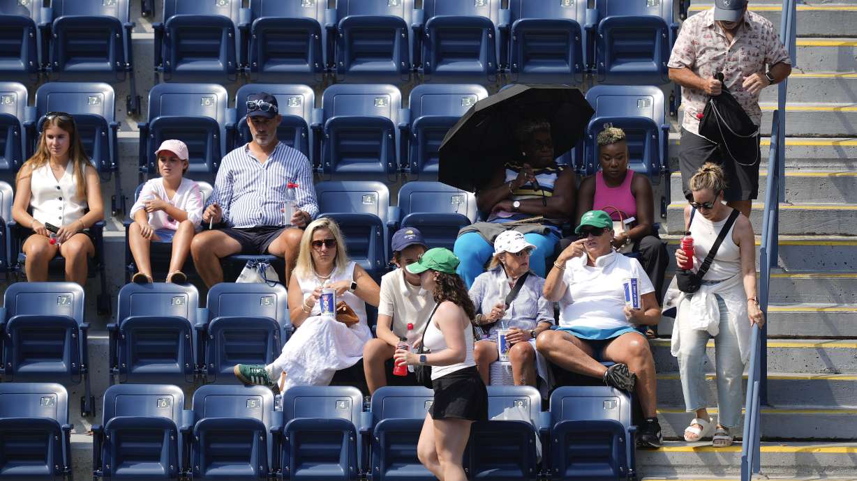 Spectators move to their seats during play between Varvara Gracheva, of France, and Coco Gauff, of the United States, during the first round of the U.S. Open tennis championships, Monday, Aug. 26, 2024, in New York.