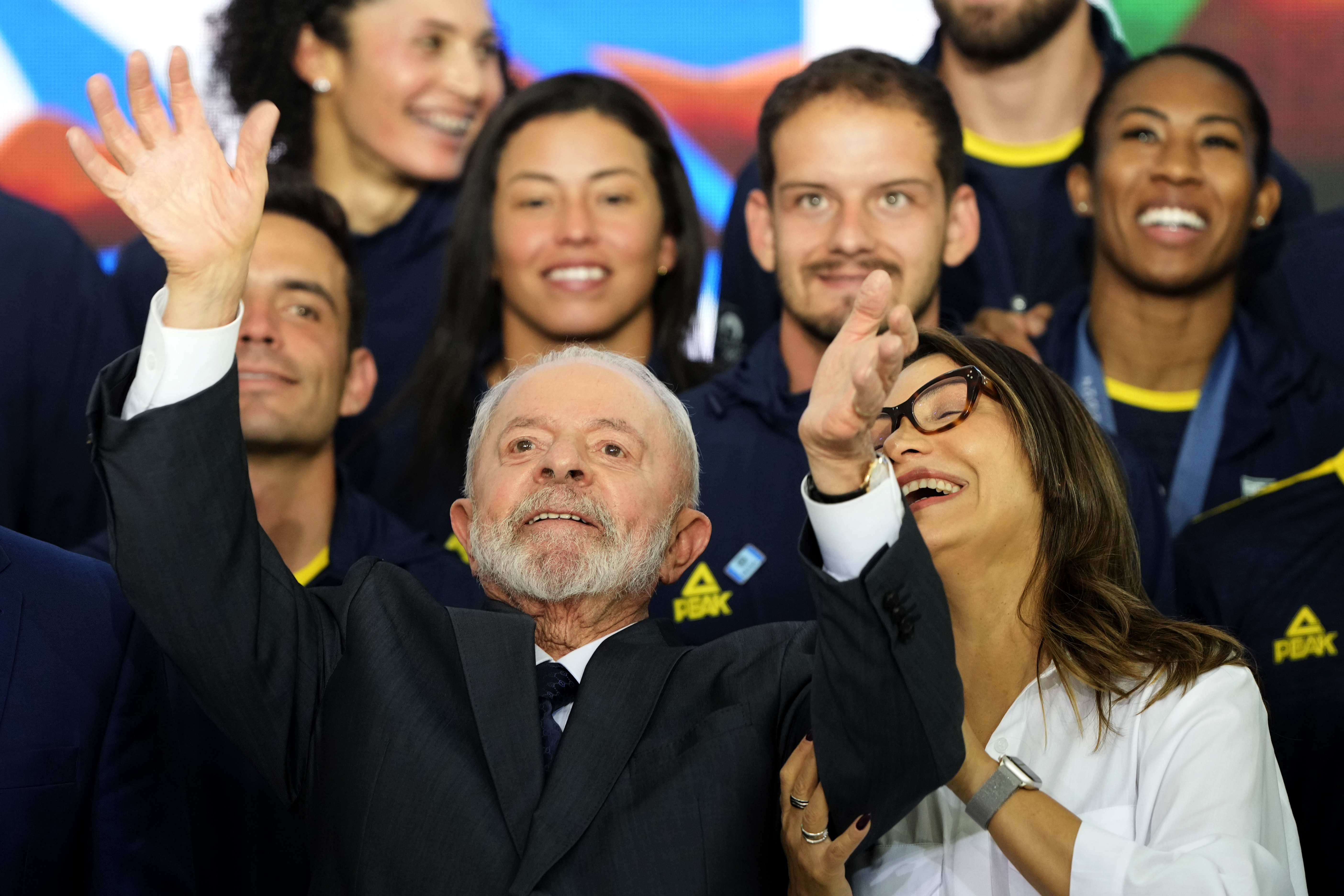 Brazil's President Luiz Inacio Lula da Silva celebrates with the first lady Rosangela da Silva and athletes from the Brazilian delegation who participated in the Paris Olympic Games, during a meeting at the Planalto presidential palace, in Brasilia, Brazil, Monday, Aug. 26, 2024.