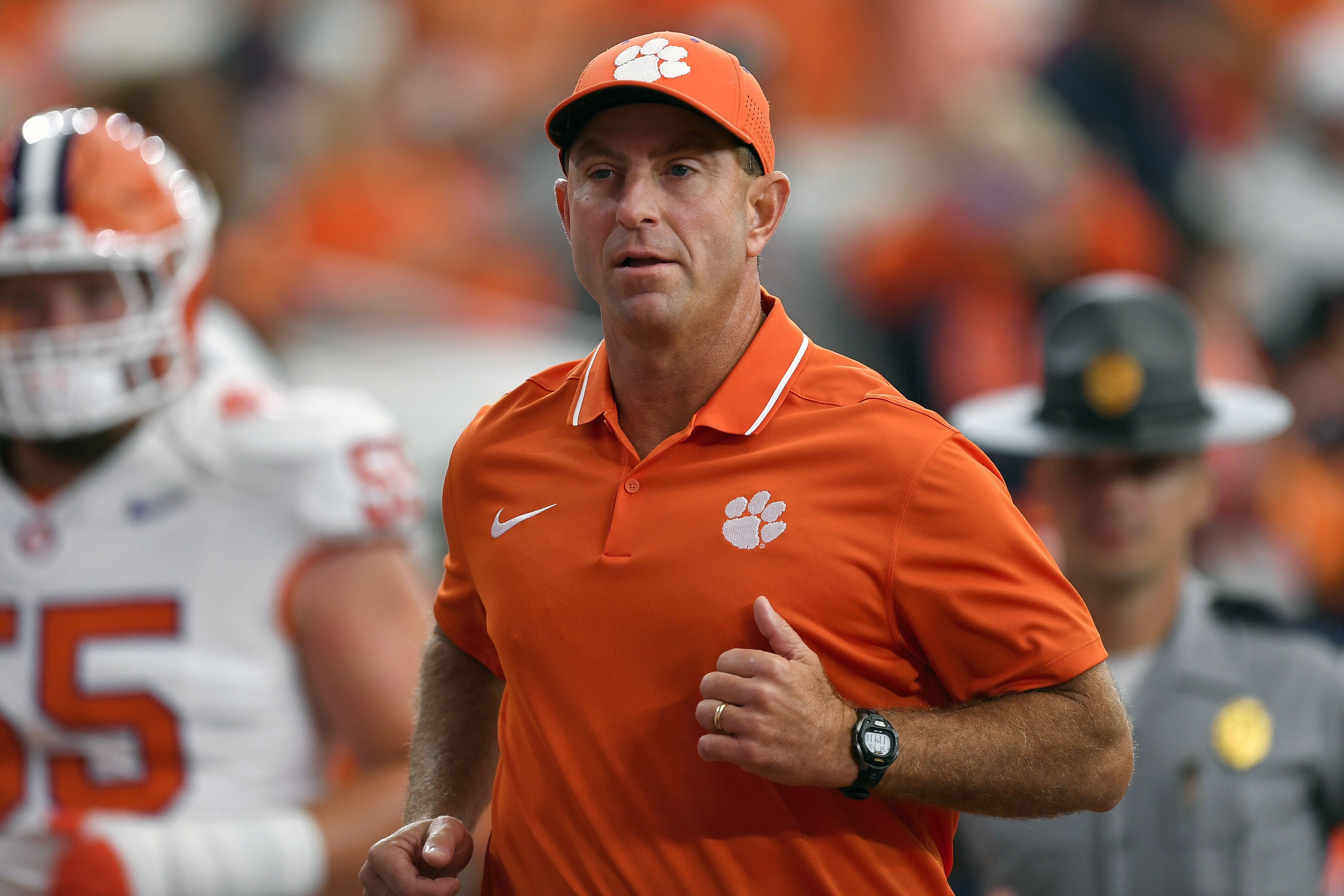 FILE - Clemson head coach Dabo Swinney runs on the field during the first half of an NCAA college football game against Syracuse in Syracuse, N.Y., Sept. 30, 2023. 