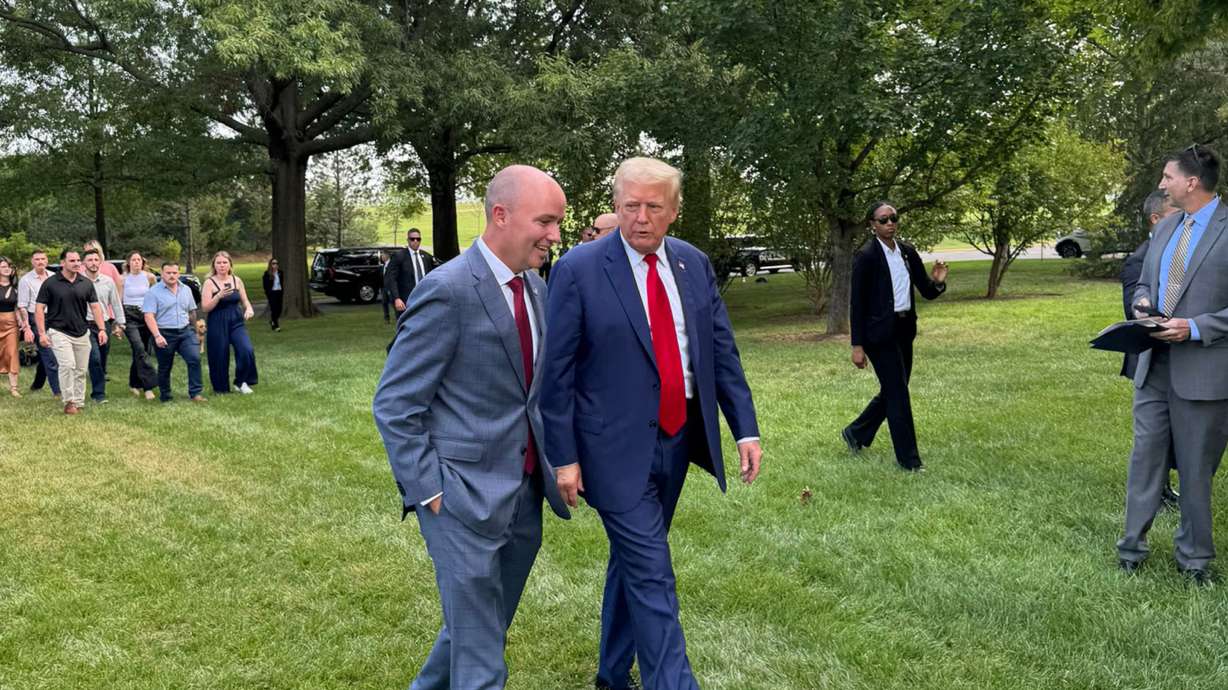 Gov. Spencer Cox walks with former President Donald Trump during a press event at Arlington National Cemetery, Monday, in Arlington, Va. A majority of Utah voters said they approve of Cox's endorsement of Trump.