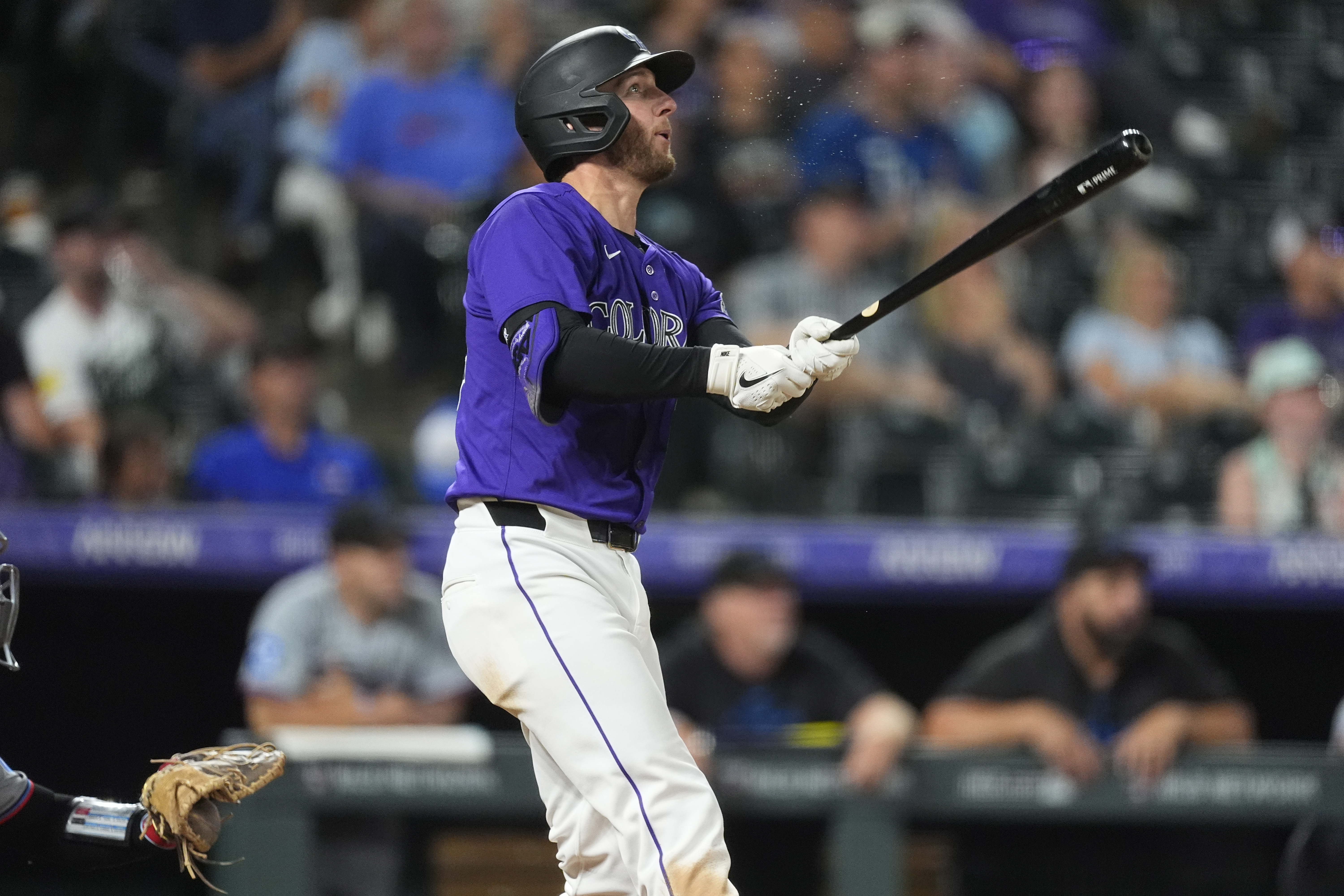 Colorado Rockies' Ryan McMahon follows the flight of his solo home run off Miami Marlins starting pitcher Edward Cabrera in the sixth inning of a baseball game Monday, Aug. 26, 2024, in Denver. 