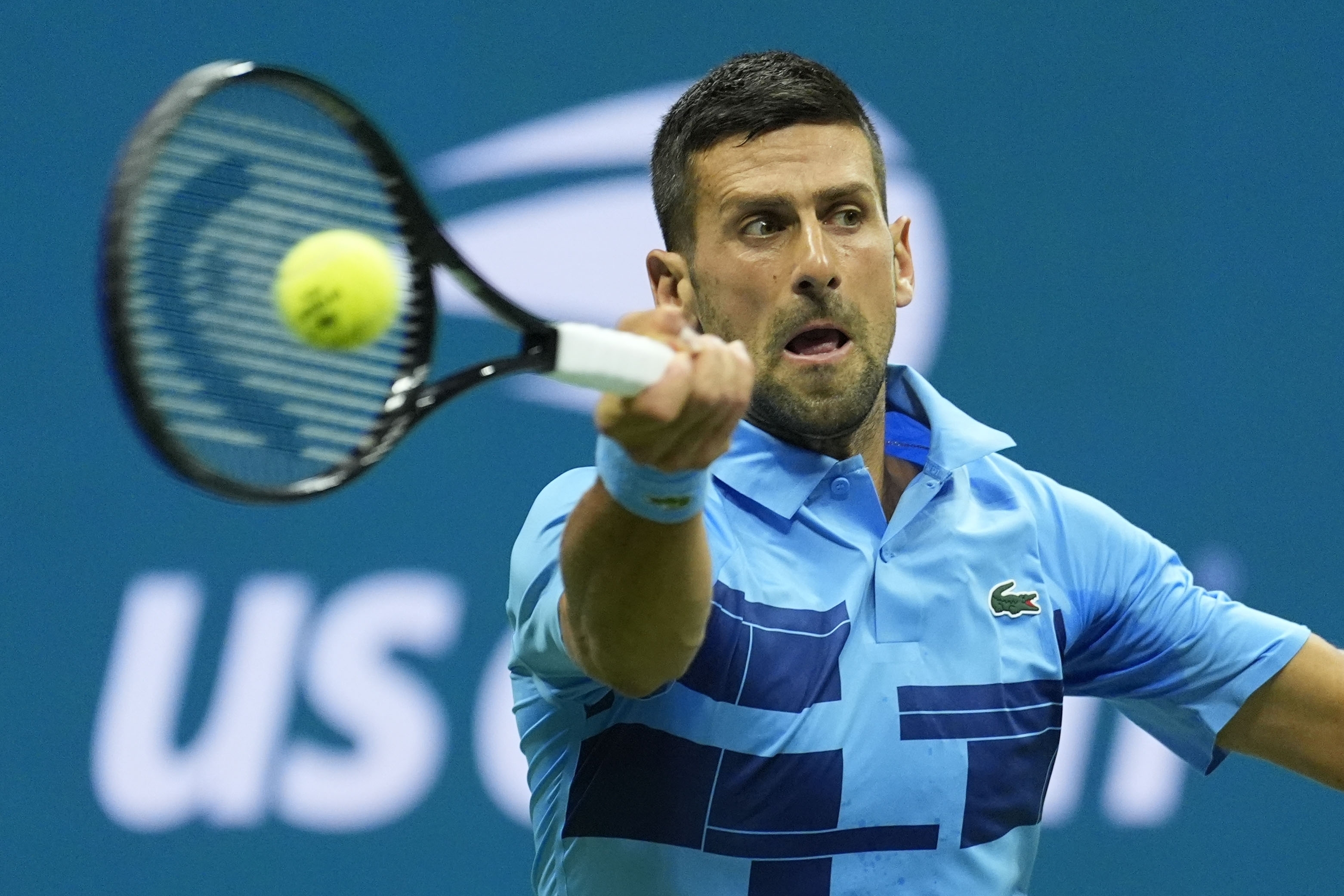 Novak Djokovic, of Serbia, returns a shot to Radu Albot, of Moldova, during a first round match of the U.S. Open tennis championships, Monday, Aug. 26, 2024, in New York. 