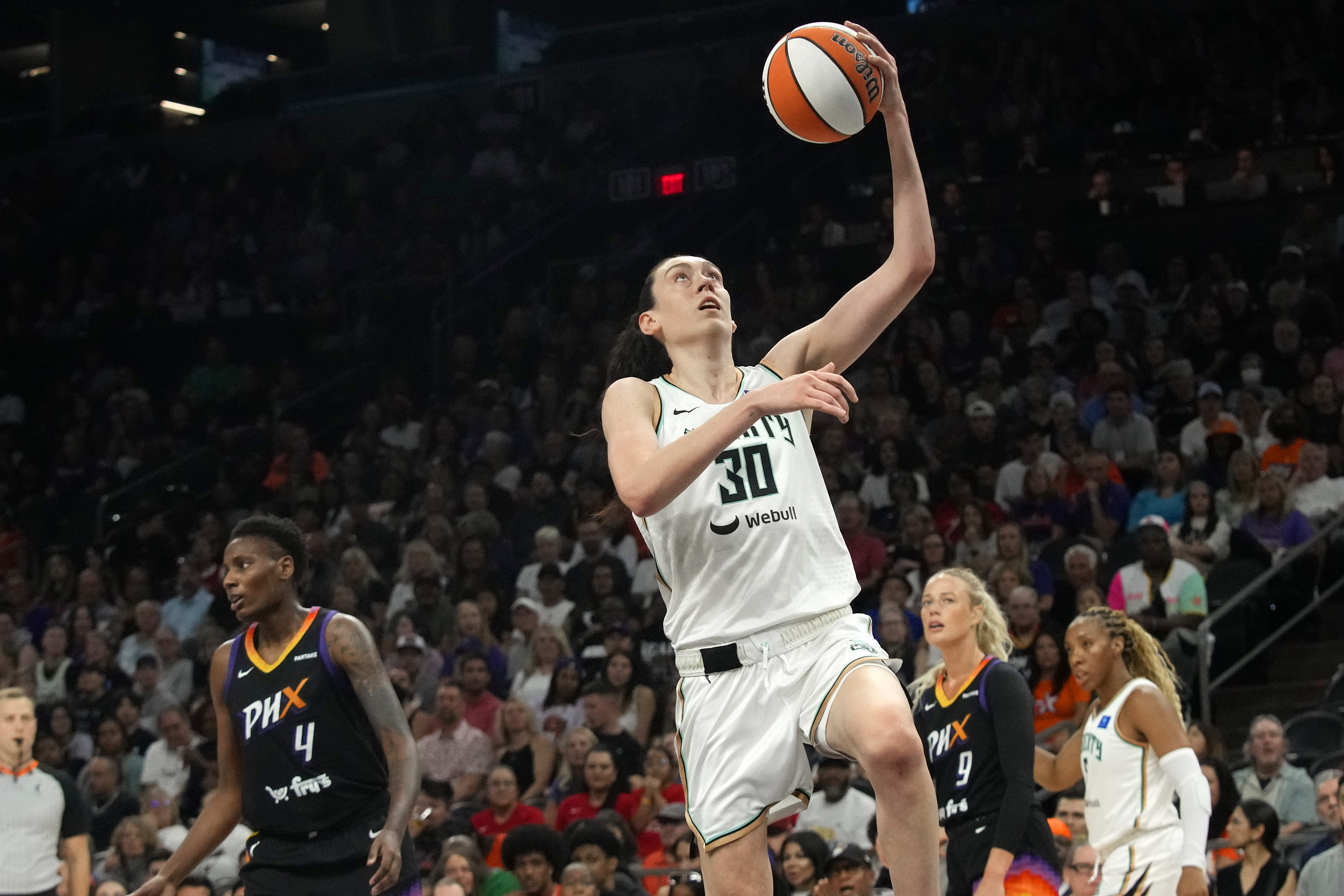 New York Liberty forward Breanna Stewart (30) drives past Phoenix Mercury forward Natasha Mack (4) to score during the first half of a WNBA basketball game Monday, Aug. 26, 2024, in Phoenix.