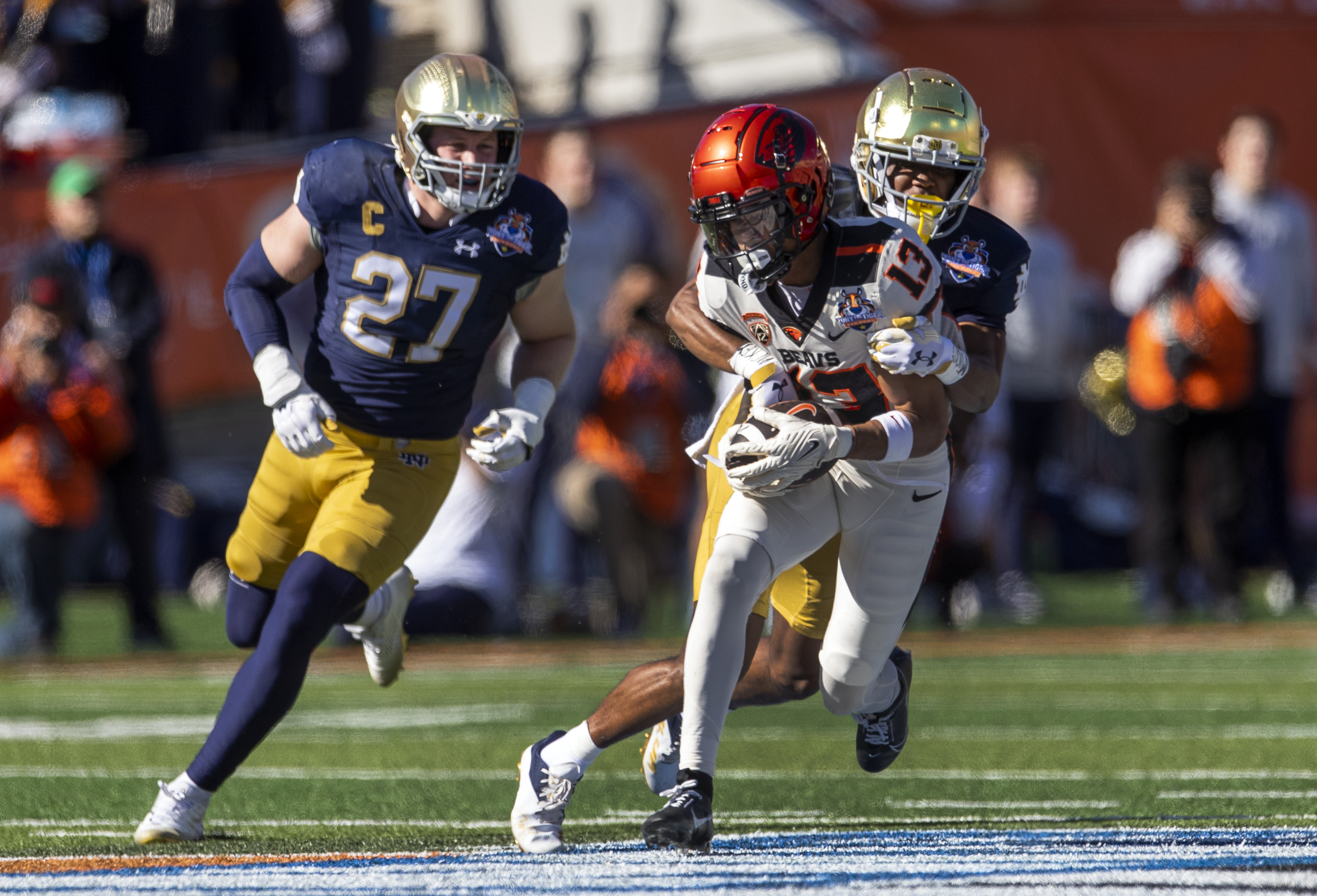 FILE - Oregon State wide receiver Jesiah Irish (13) is tackled by Notre Dame cornerback Benjamin Morrison (20) during the first half of the Sun Bowl NCAA college football game, Dec. 29, 2023, in El Paso, Texas. 