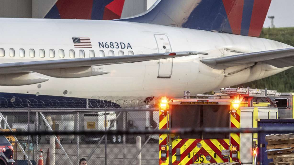 Multiple Atlanta Fire Rescue Department units and police park outside a Delta Maintenance facility near Hartsfield-Jackson International Airport early Tuesday in Atlanta. Two workers are dead and a third is seriously injured after a tire explosion.