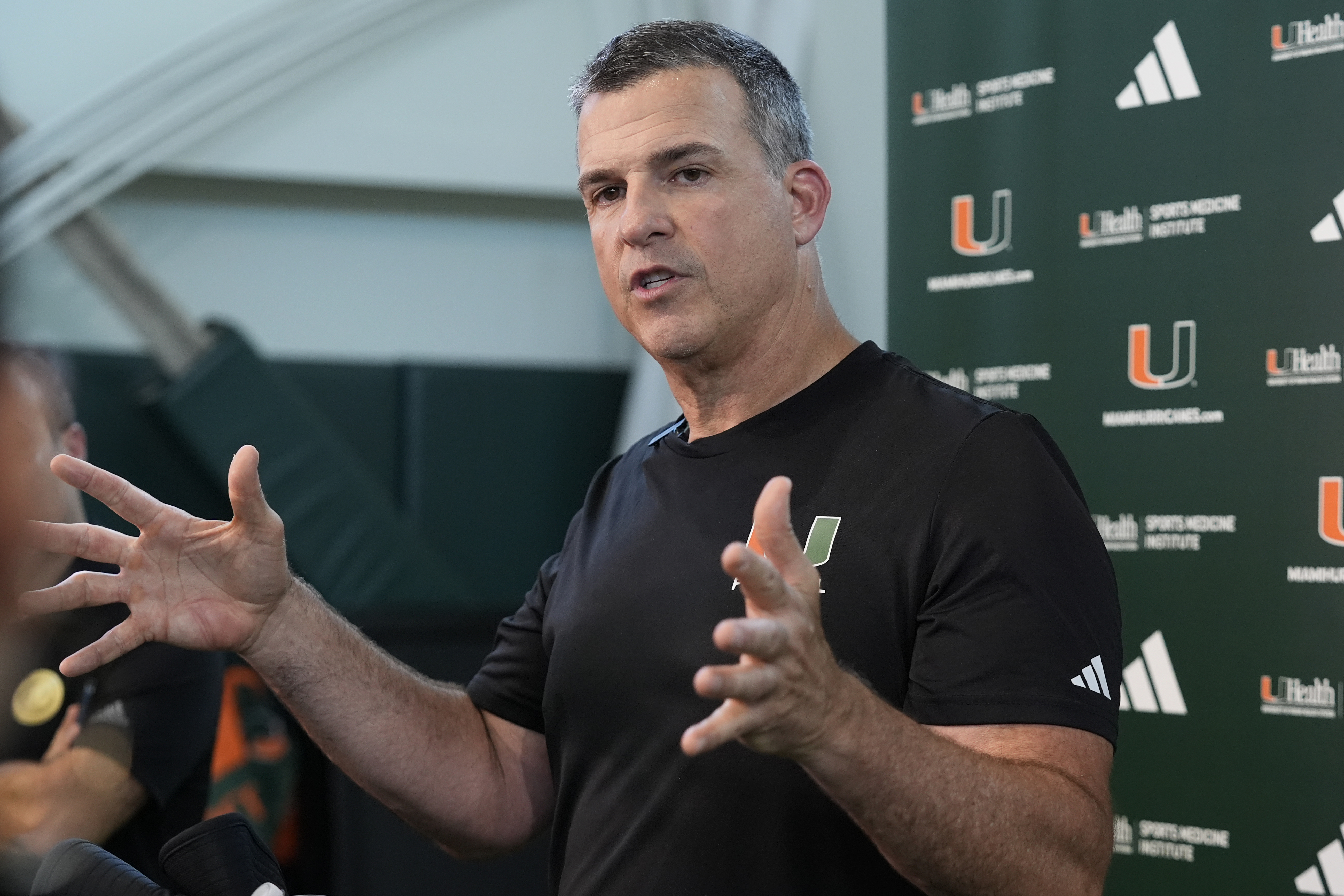 Miami head coach Mario Cristobal speaks with the media following NCAA college football practice, Wednesday, July 31, 2024, in Coral Gables, Fla. 